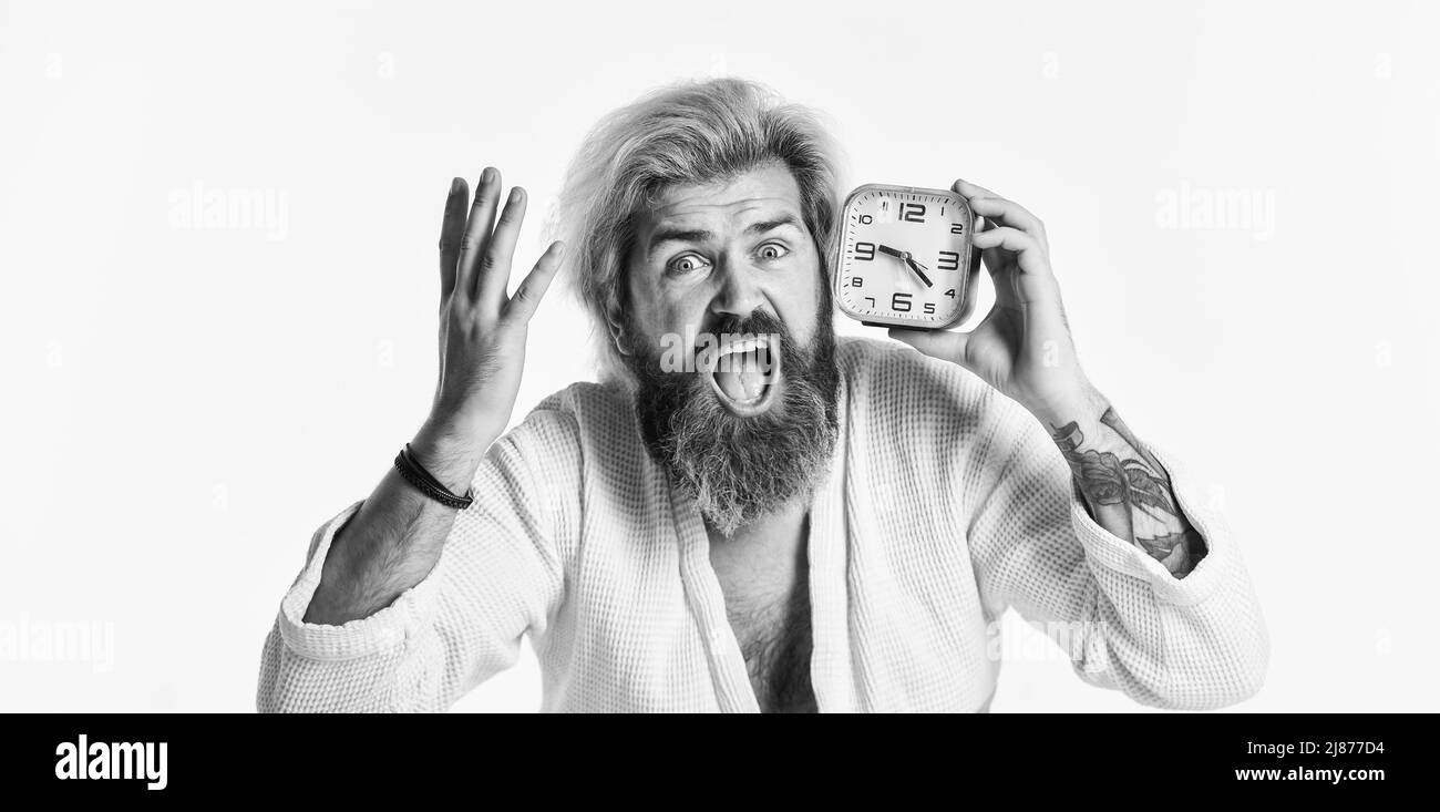 Sleep disorder. Sleepy guy and alarm clock in bed. Awakening concept