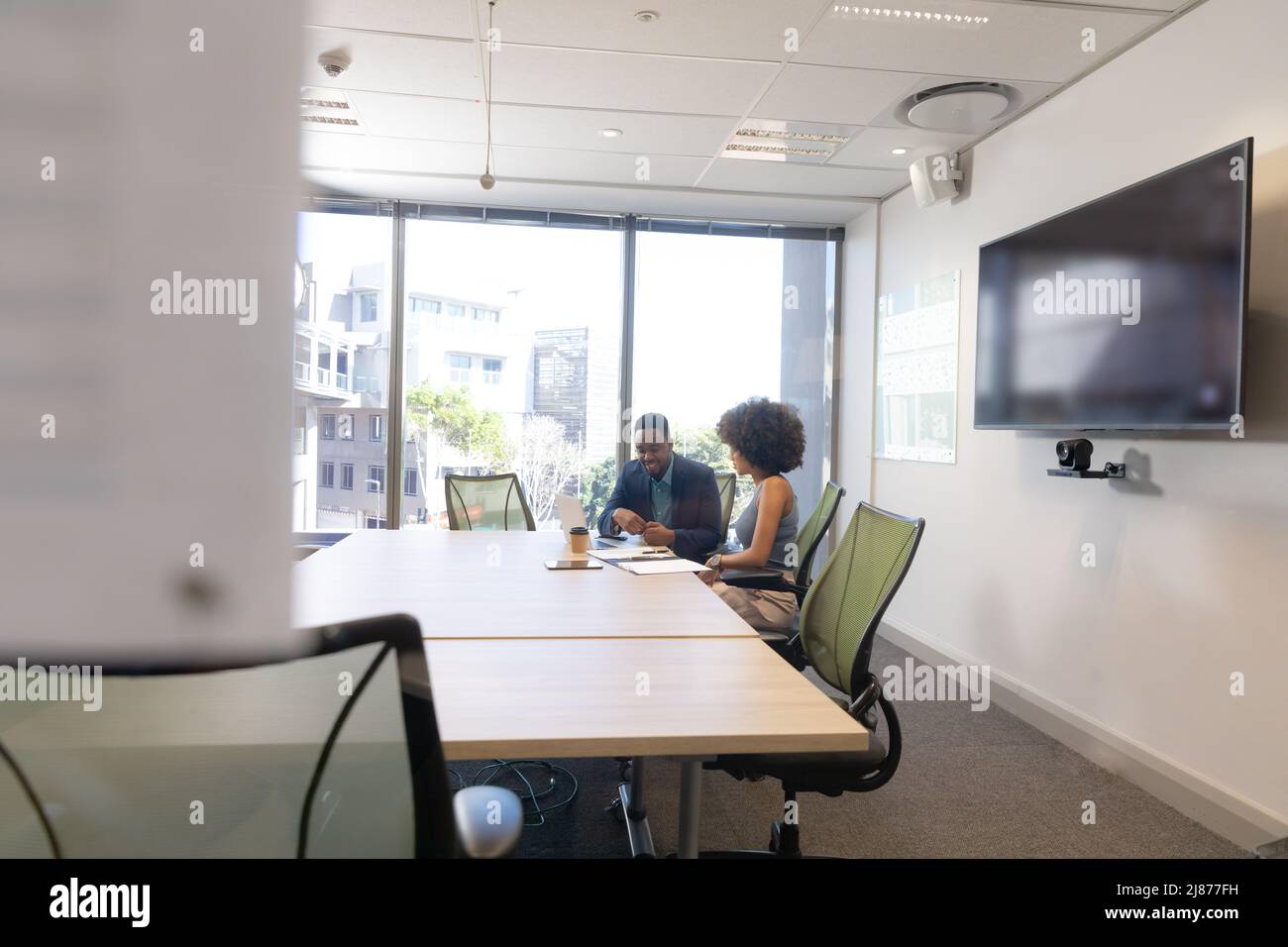 Multiracial business colleagues planning strategy in boardroom during ...