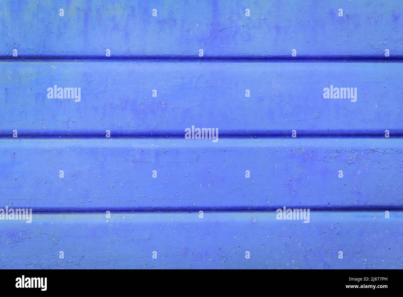 Old metal surface in blue paint with horizontal lines fence pattern texture background. Stock Photo