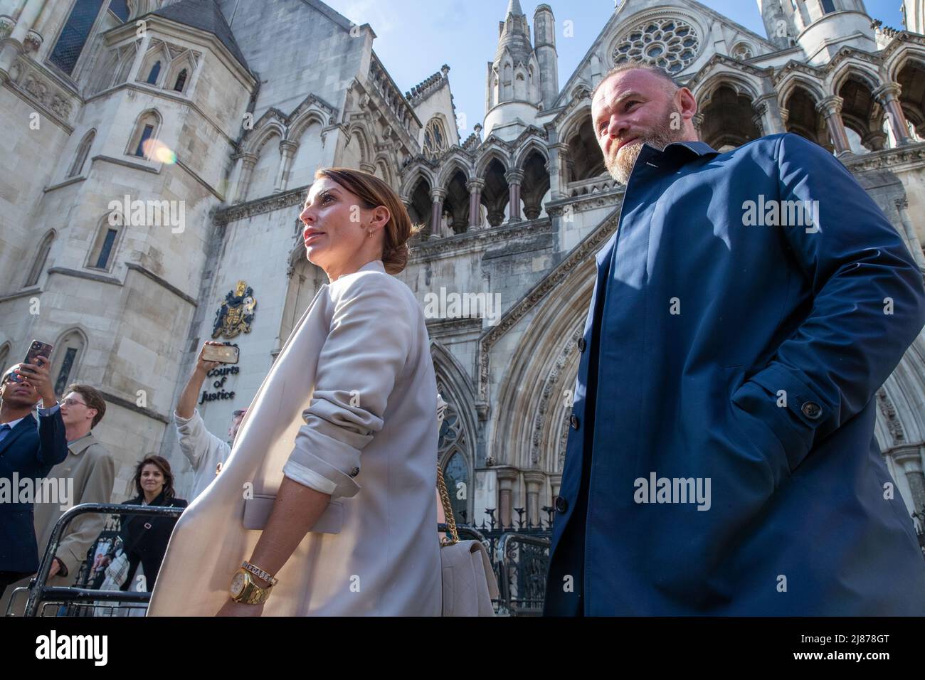 London, UK. 13th May, 2022. Coleen Rooney and Wayne Rooney leaves The Royal Courts of Justice after her libel case with Rebekah Vardy, Coleen Rooney who is the wife of Derby County manager and former England football player Wayne Rooney, and Rebekah Vardy, wife of Leicester City striker Jamie Vardy are locked in a libel battle also known as the 'Wagatha Christie' trial after accusations that Mrs Vardy leaked false stories about Mrs Rooney to the press. Credit: Lucy North/Alamy Live News Stock Photo