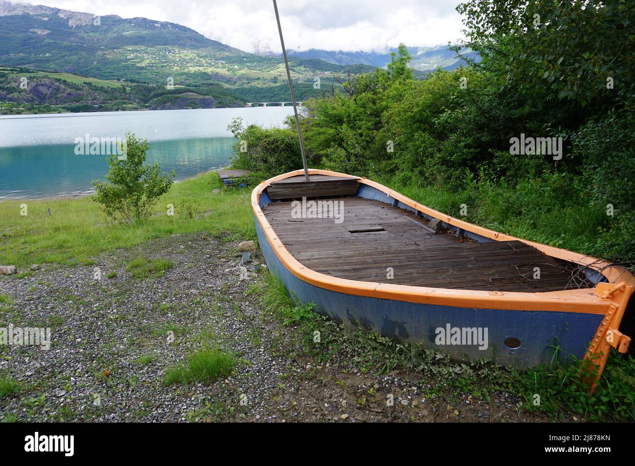 colorful abandoned old wood boat  near the lake in Serre Ponçon, Southern Alps, France Stock Photo