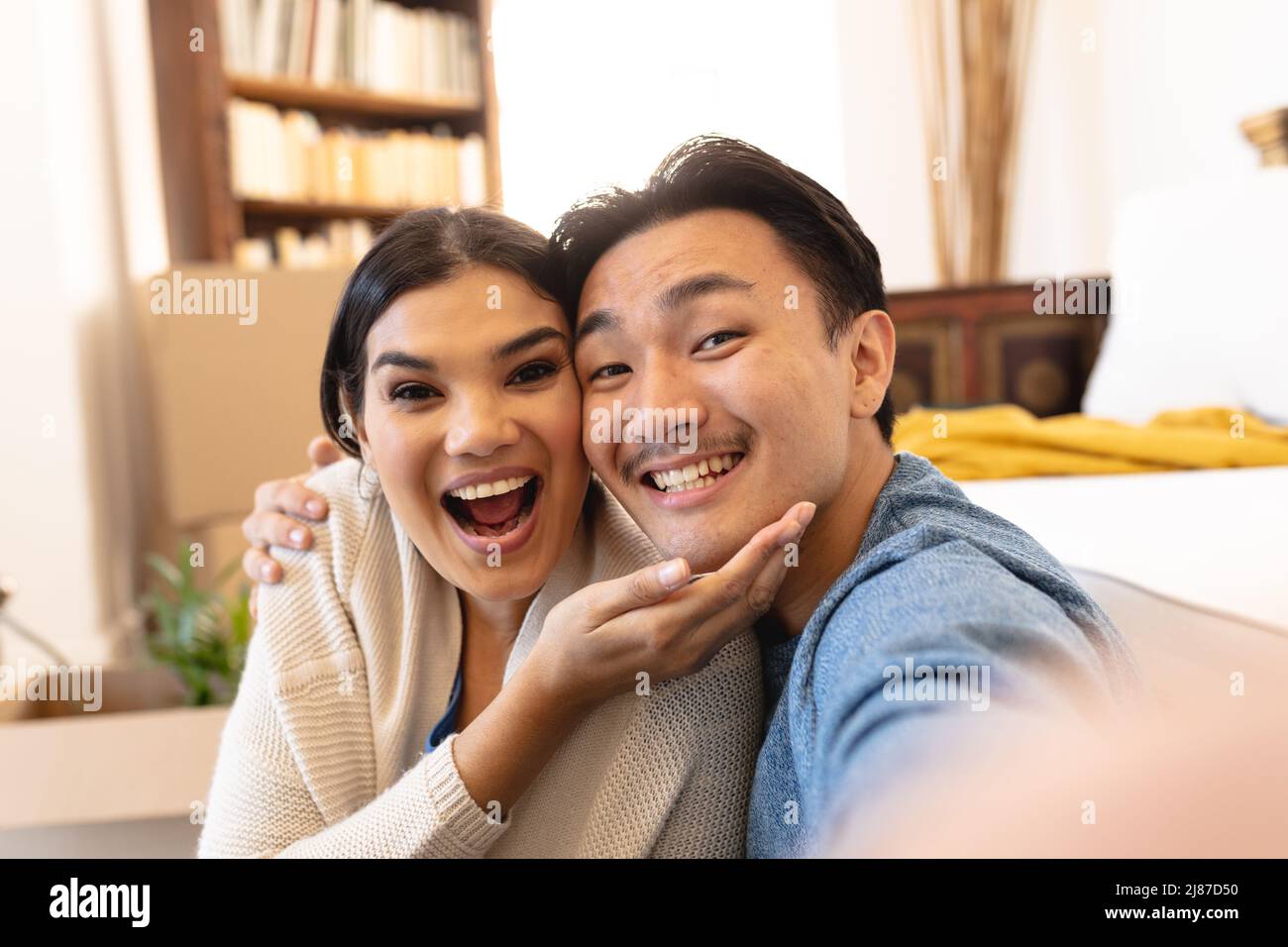 Portrait of happy young asian couple enjoying liesure time at home Stock Photo