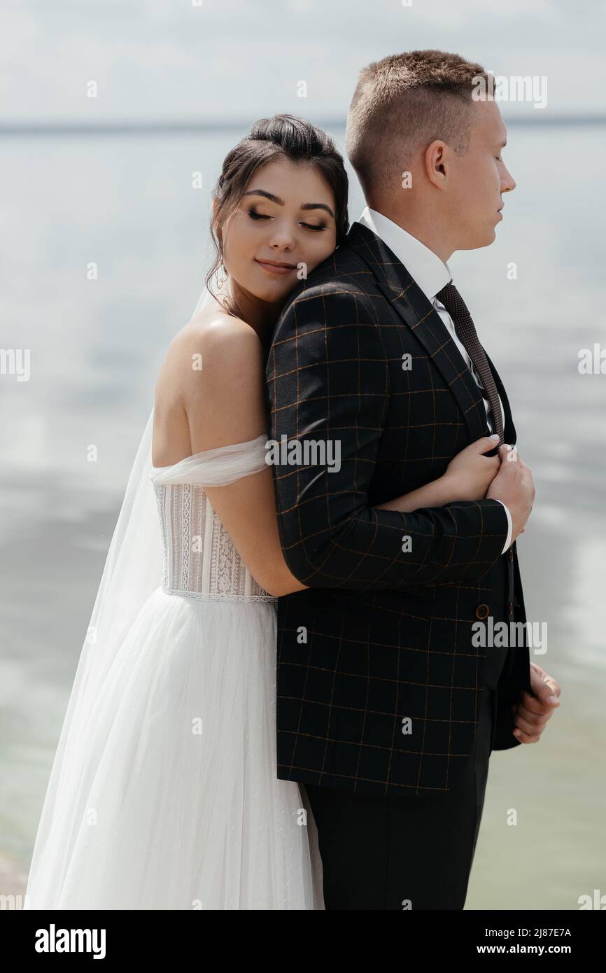 Newlyweds standing on river bank hi-res stock photography and images ...