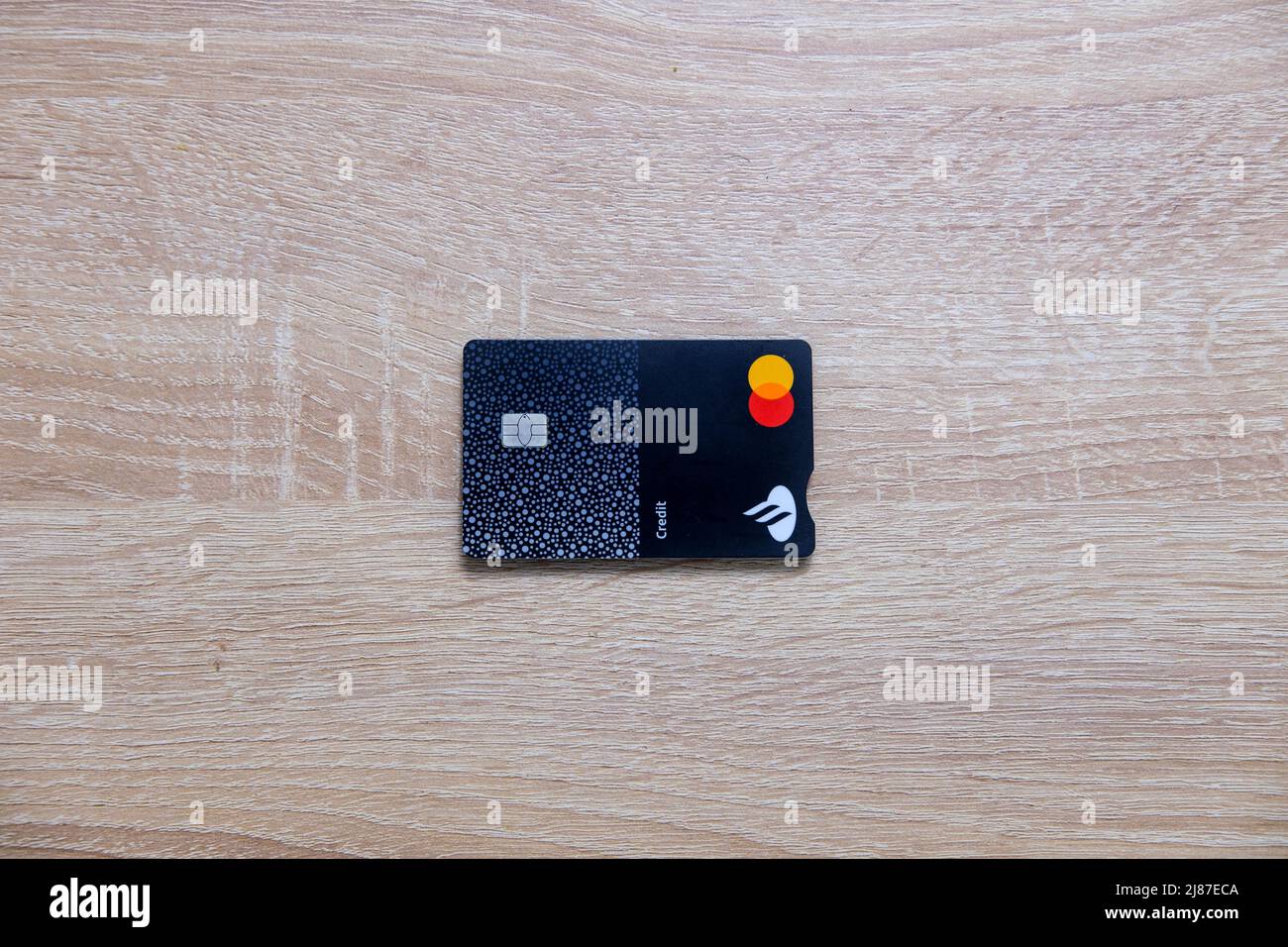 Castelo Branco, Portugal - May 13 2022: Top down shot of Santander credit card on wood counter Stock Photo