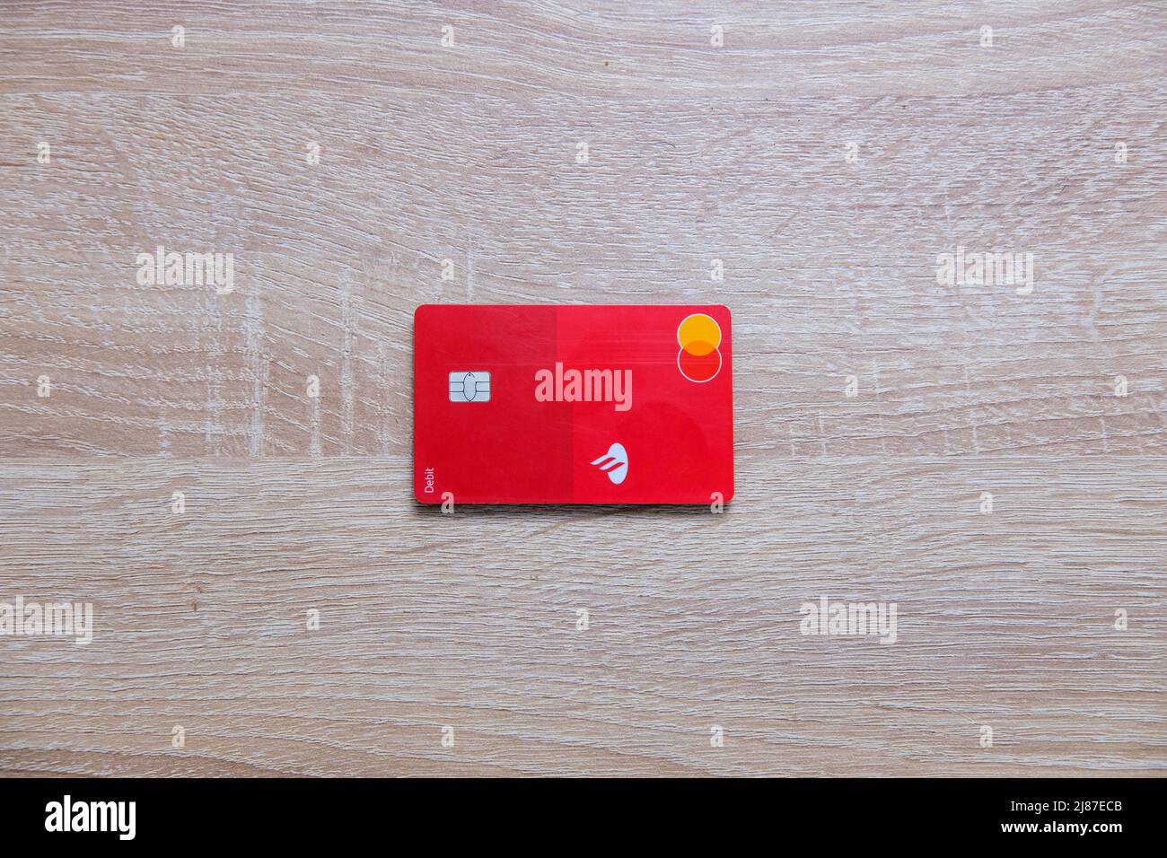 Castelo Branco, Portugal - May 13 2022: Top down shot of Santander Debit card on wood counter Stock Photo