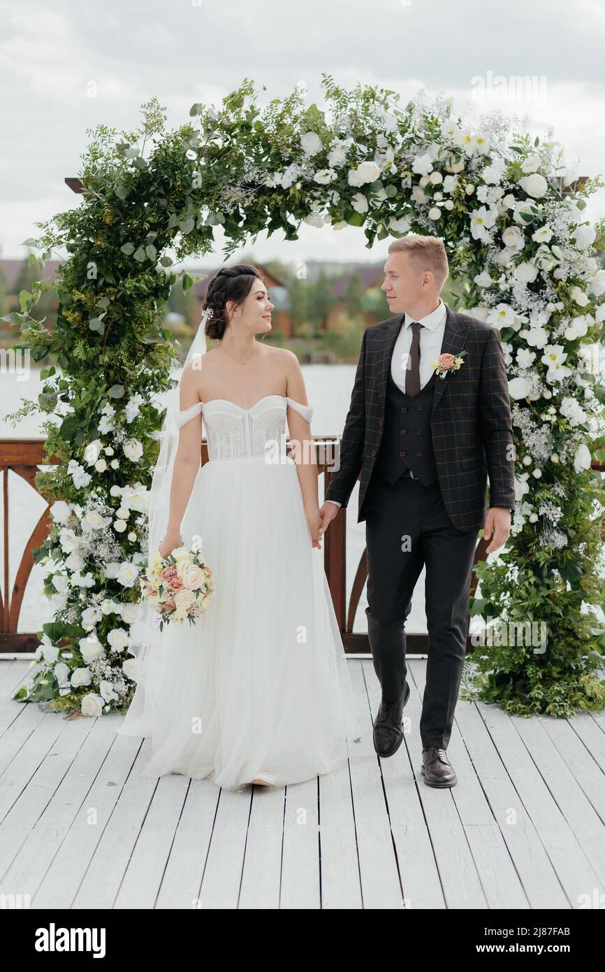 Cute smiling newlyweds go hi-res stock photography and images - Alamy