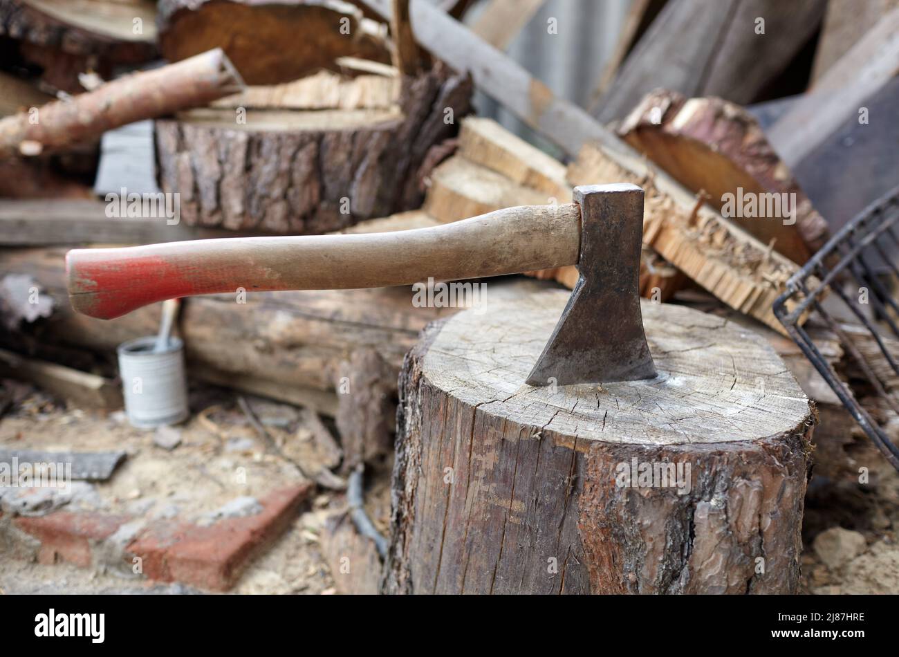Ax in the stump. Axe for cutting wood. Preparation of firewood for the winter. Selective focus, blurred background Stock Photo