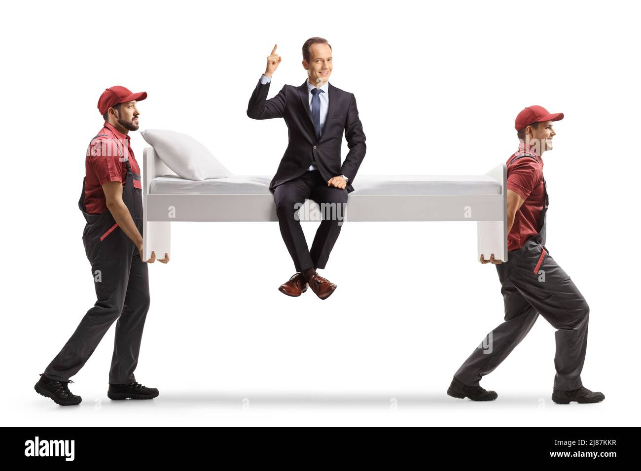 Movers carrying a bed with a businessman sitting and pointing up