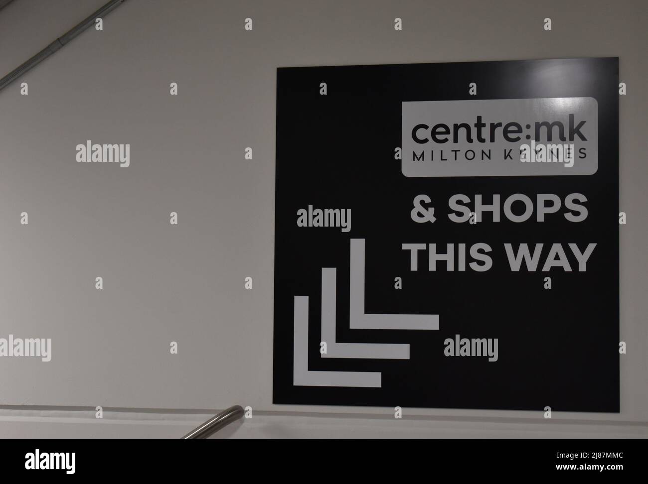 A sign showing the way to the shops in a multistorey car park in Milton Keynes Stock Photo Alamy