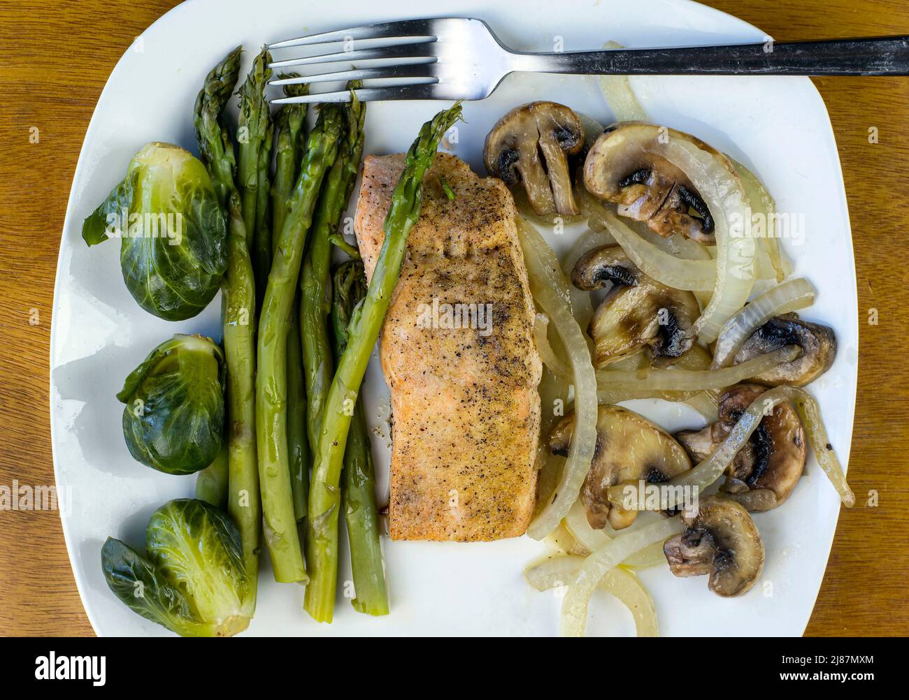 baked season salmon with sauteed onions and mushrooms Stock Photo - Alamy
