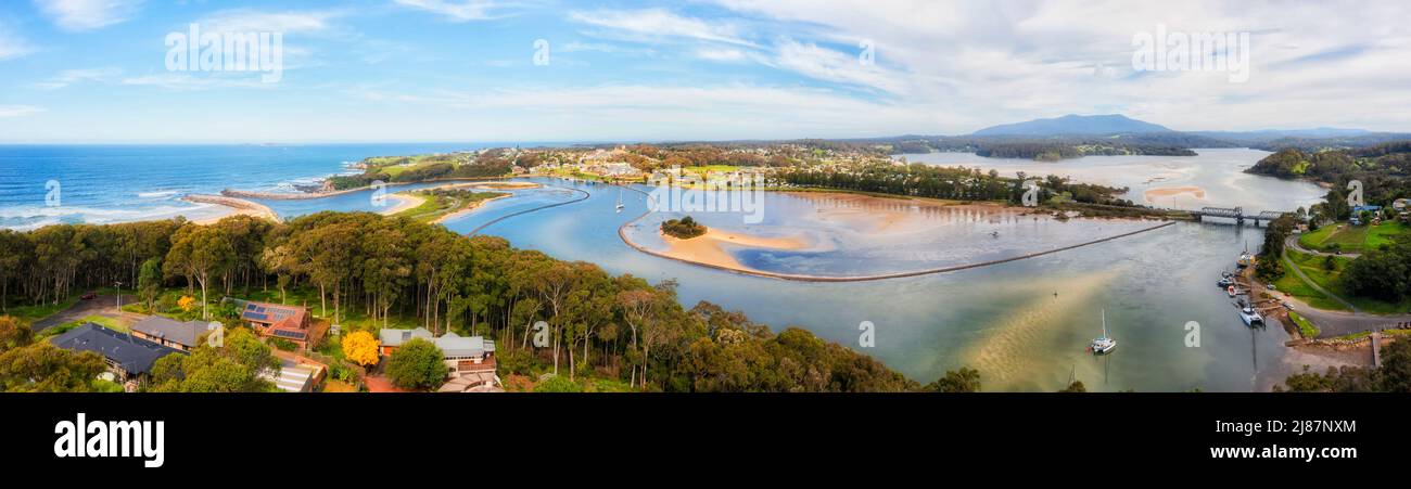 Aerial panorama over Narooma town river inlet on the South Coast of NSW, Australia - aquaculture oyster fishing farms. Stock Photo