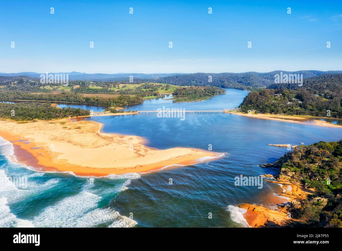 Bega river entrance to Pacific ocean at Sapphire coast of Australia - sand dunes of Tathra beach in aerial scenic landscape. Stock Photo