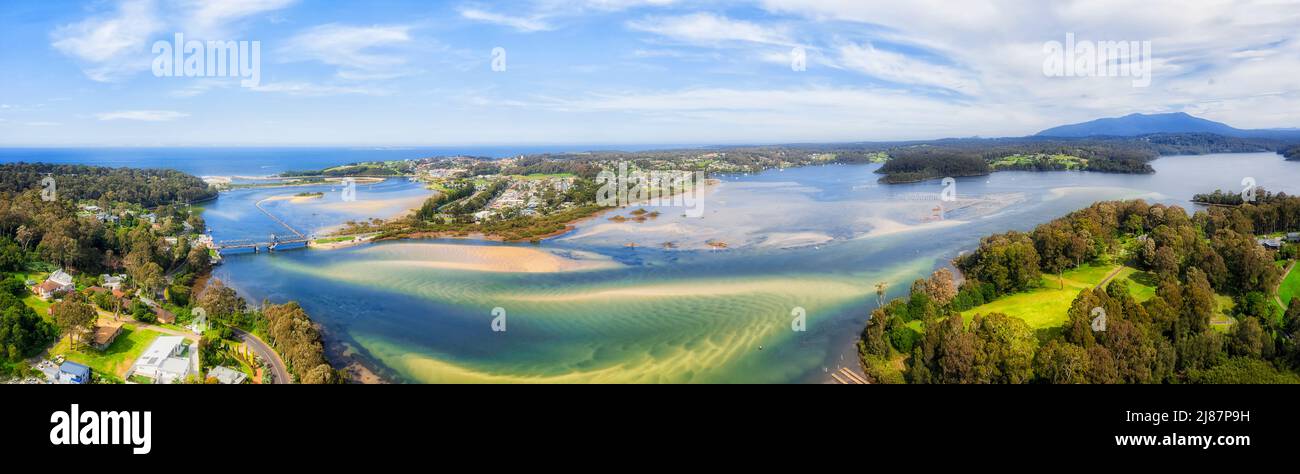 Wagonga fresh water inlet on Pacific South coast of Austrlia with aquaculture oyster farms seafood shellfish production - aerial panorama. Stock Photo