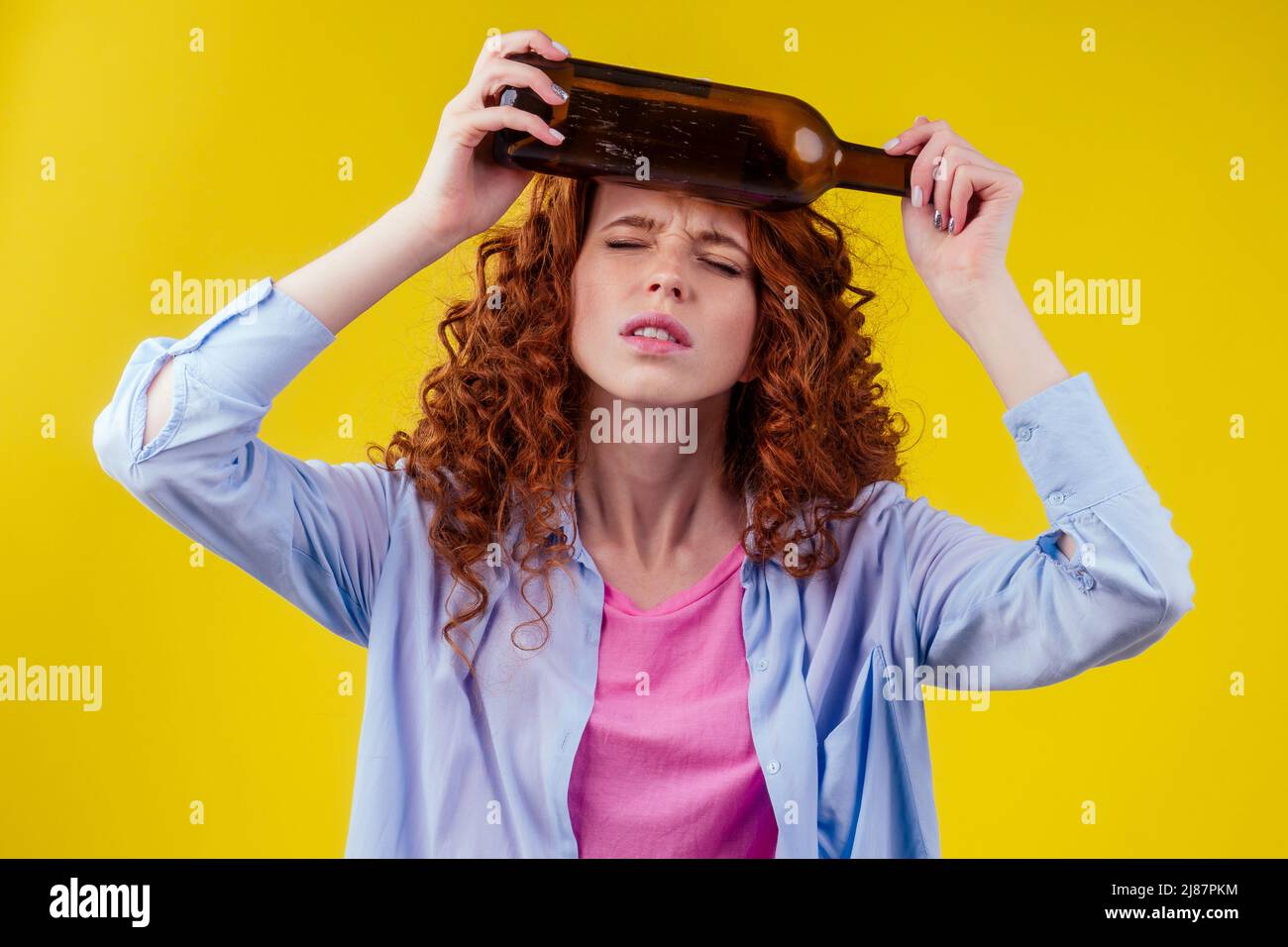 curly redhead ginger woman drinking beer and feeling bad mood in csudio