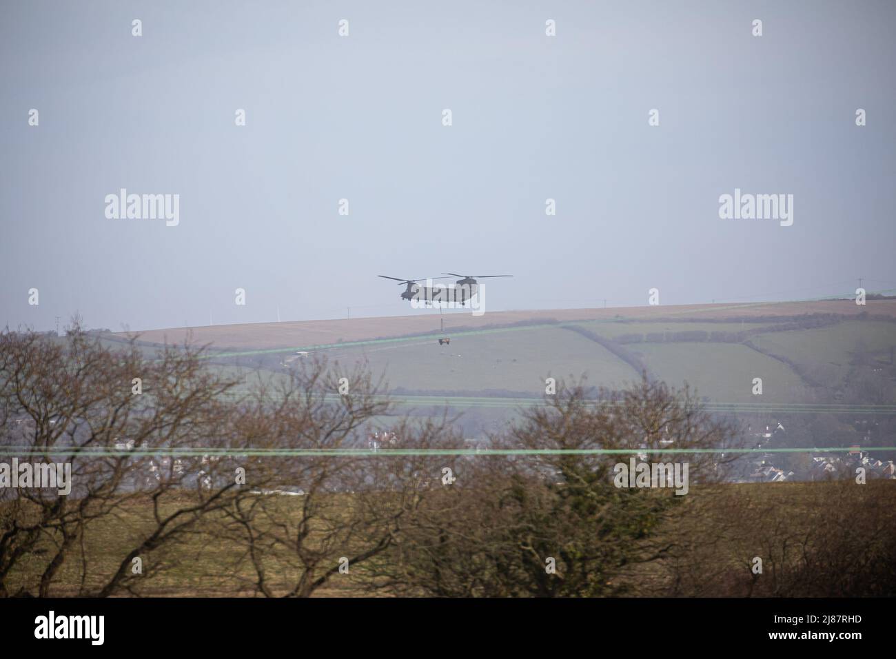 Views from Yelland Quay in North Devon as military Chinook exercise flying from RMB Chivenor over Braunton Burrows. The helicopter was seen transporting a Landrover Defender and Trailer back and forth from the Braunton Burrows to RMB Chivenor, Devon, United Kingdom Featuring: View, Royal Marines Where: Yelland, Devon, United Kingdom When: 24 Mar 2021 Credit: Upright Medial/WENN Stock Photo