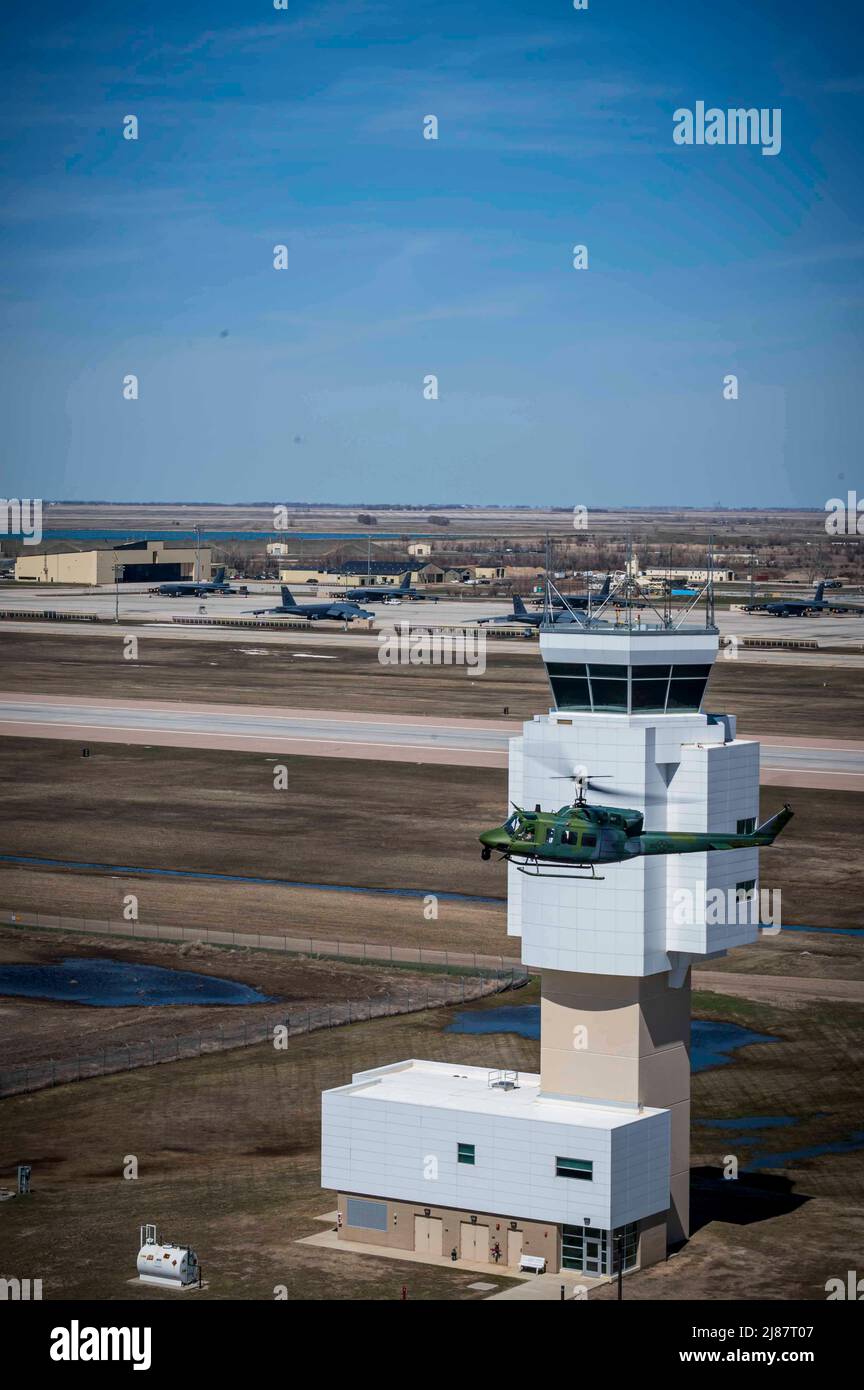 A 54th Helicopter Squadron crew flies over the flightline at Minot Air