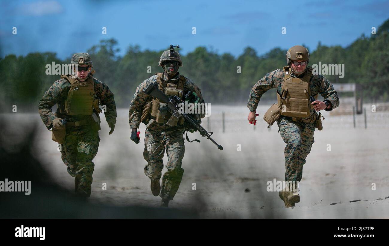 U.S. Marines with 2d Combat Engineer Battalion, 2d Marine Division, run to cover during the Sapper Leaders Course on Camp Lejeune, North Carolina, May 11, 2022. The Sapper Leaders Course provides combat engineer squad leaders with the technical and tactical proficiency required to provide mobility, counter mobility and survivability to infantry company commanders. (U.S. Marine Corps photo by Lance Cpl. Ryan Ramsammy) Stock Photo