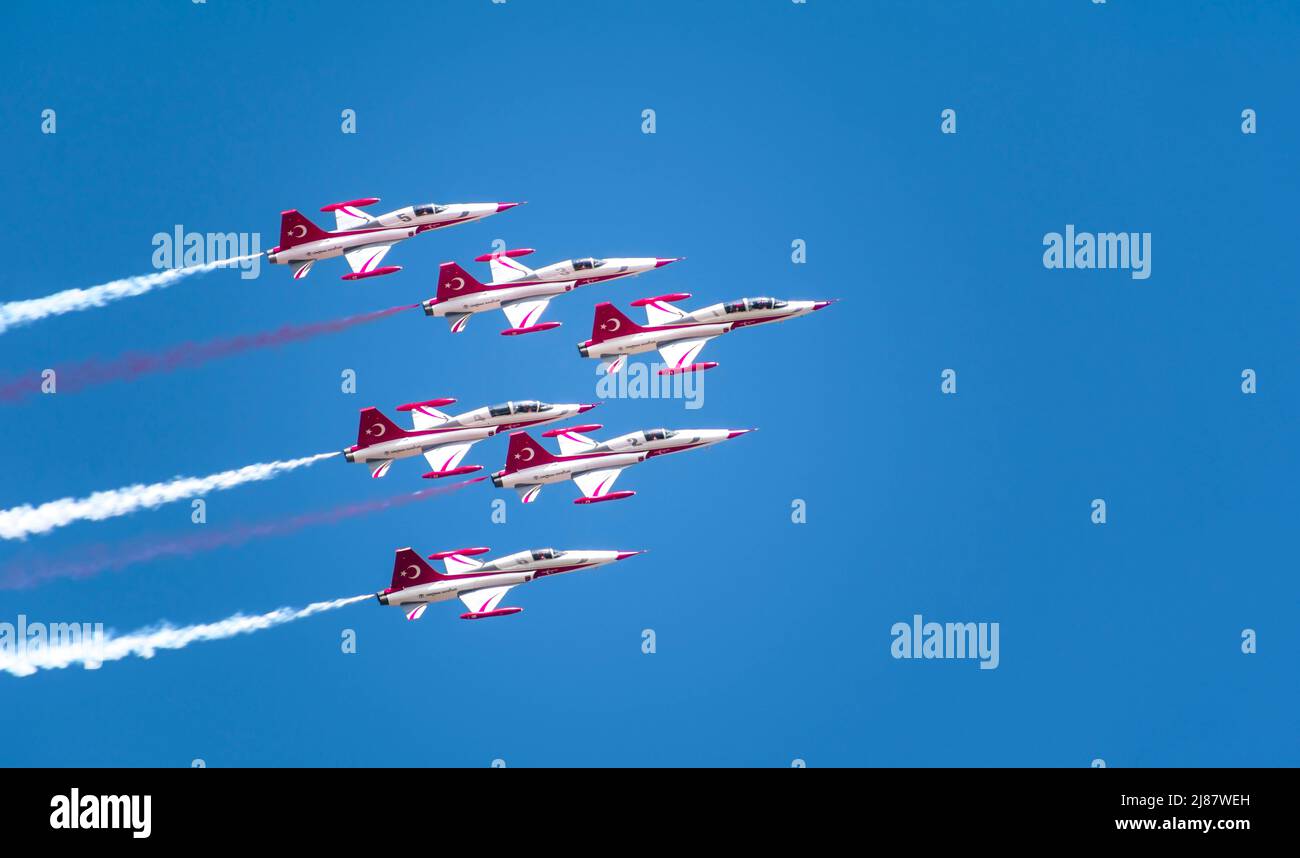Sanliurfa, Turkey - April 10, 2021: flight show of Turkish air force demonstration planes in the blue sky Stock Photo