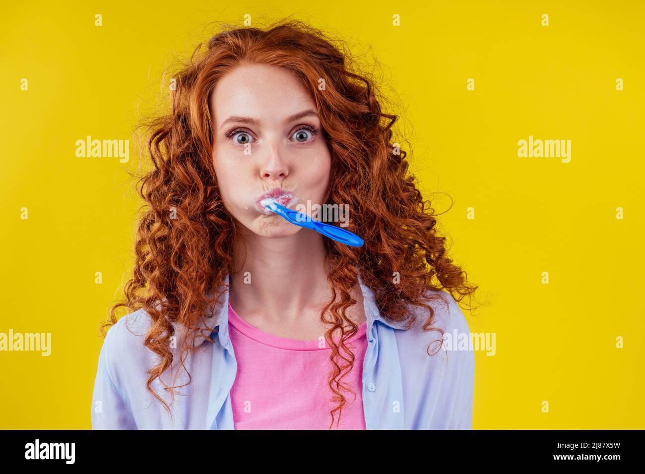 sleepy redhaired ginger woman brushing teeth with toothpaste eco paste