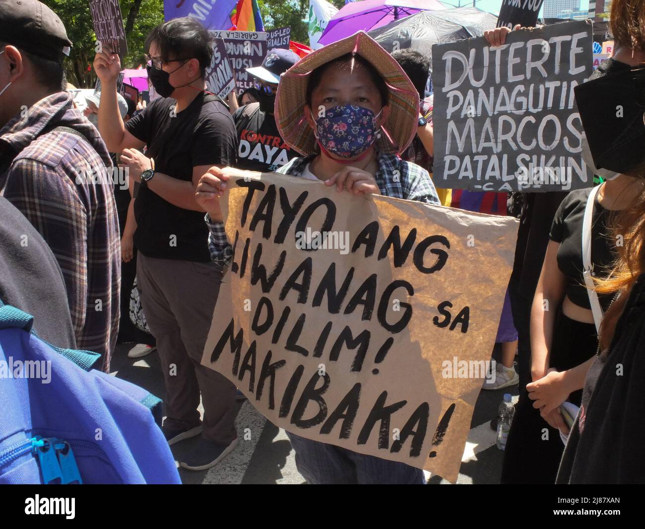 Pasay, Philippines. 13th May, 2022. A protester holds a placard ...