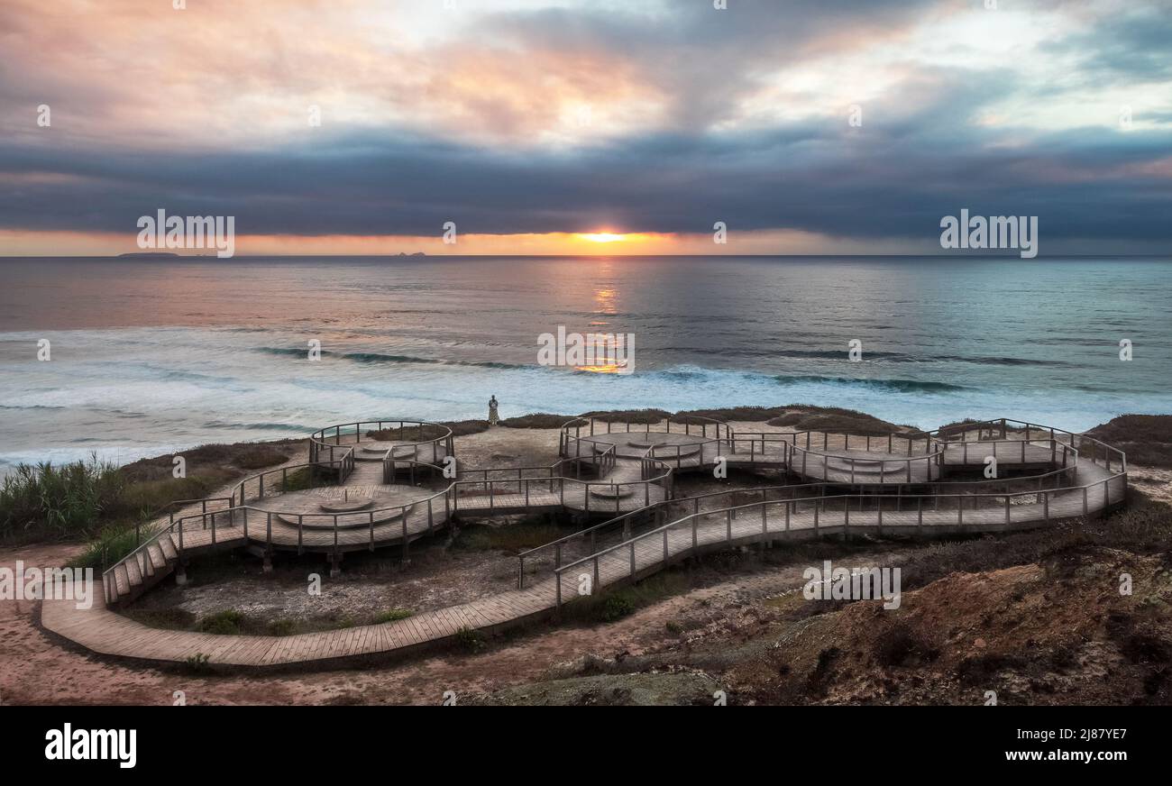 Sunset at Foz do Arelho in Portugal, with the walkways in the foreground and the sea in the background. Stock Photo