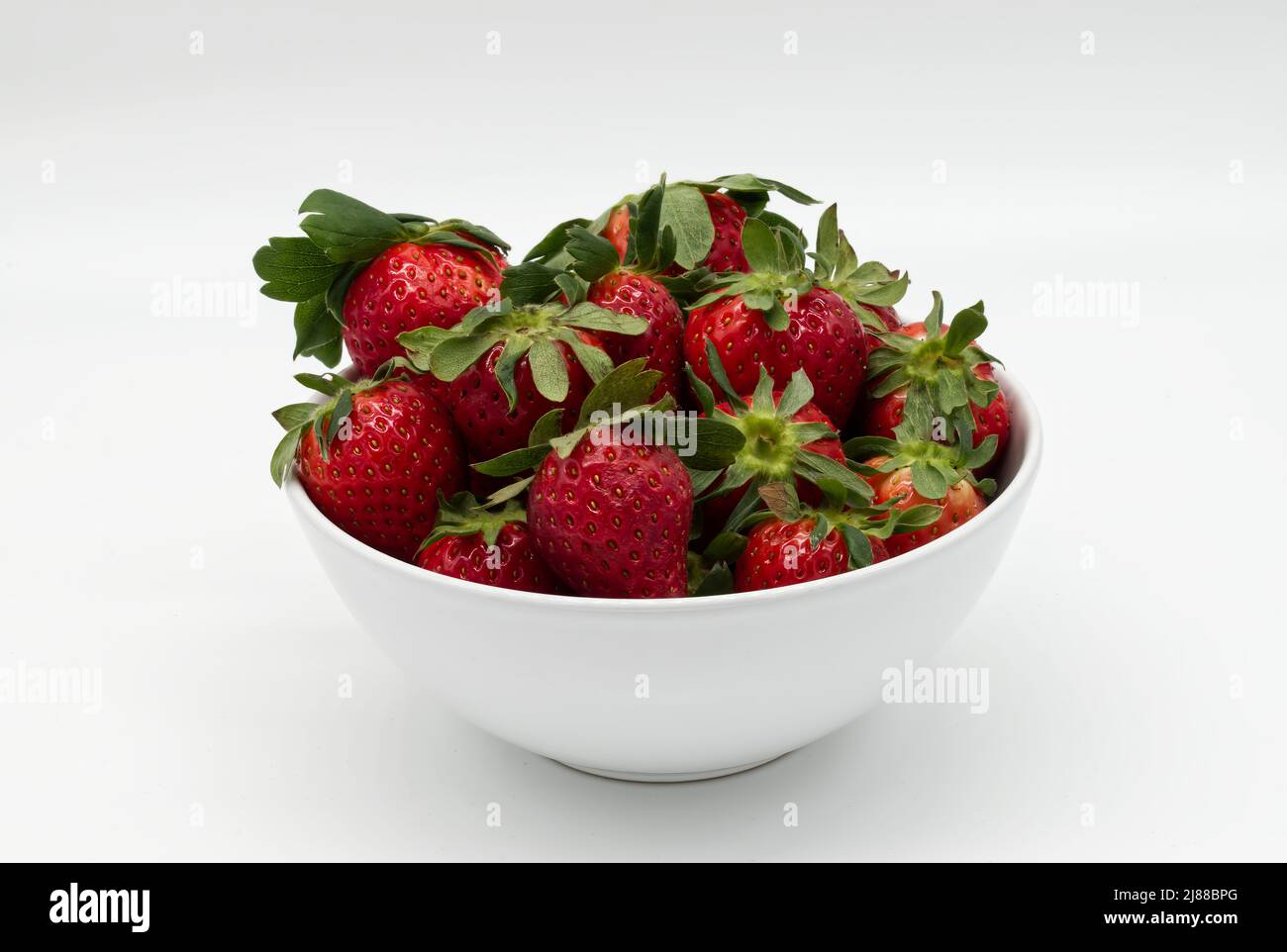 Fresh strawberry in a bowl isolated on white background Stock Photo - Alamy