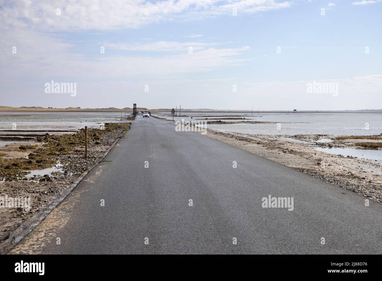 the causeway can only be crossed close to low tide at holy island lindisfarne northumberland Stock Photo