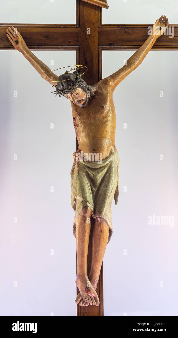 Statue of the crucified Christ, a colorful wooden statue of 1300, in the church of the Sanctuary of the Santissimo Crocefisso di Varano. Puglia Stock Photo