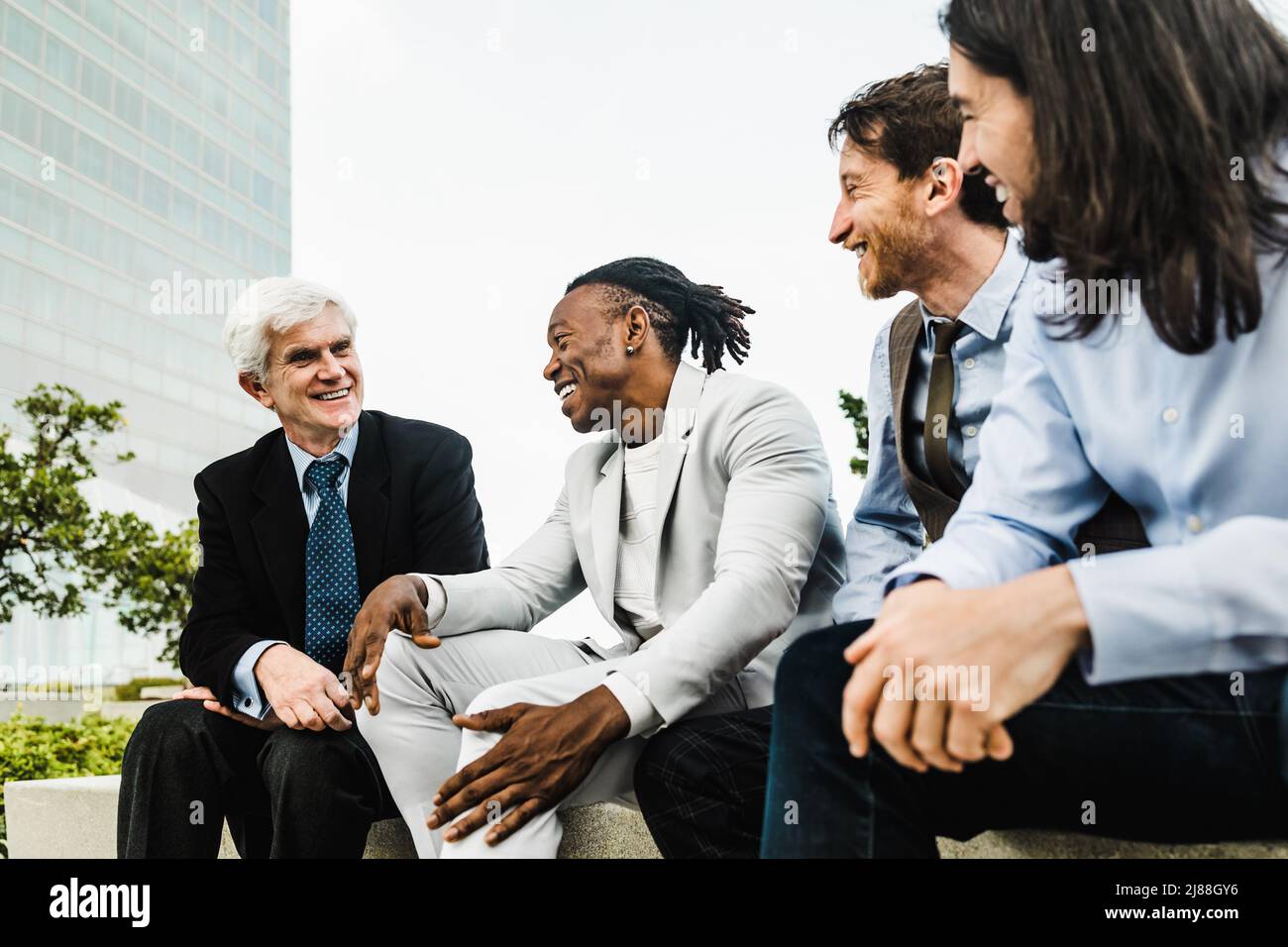 Business people with different ages and ethnicities talking together outside the office Stock Photo