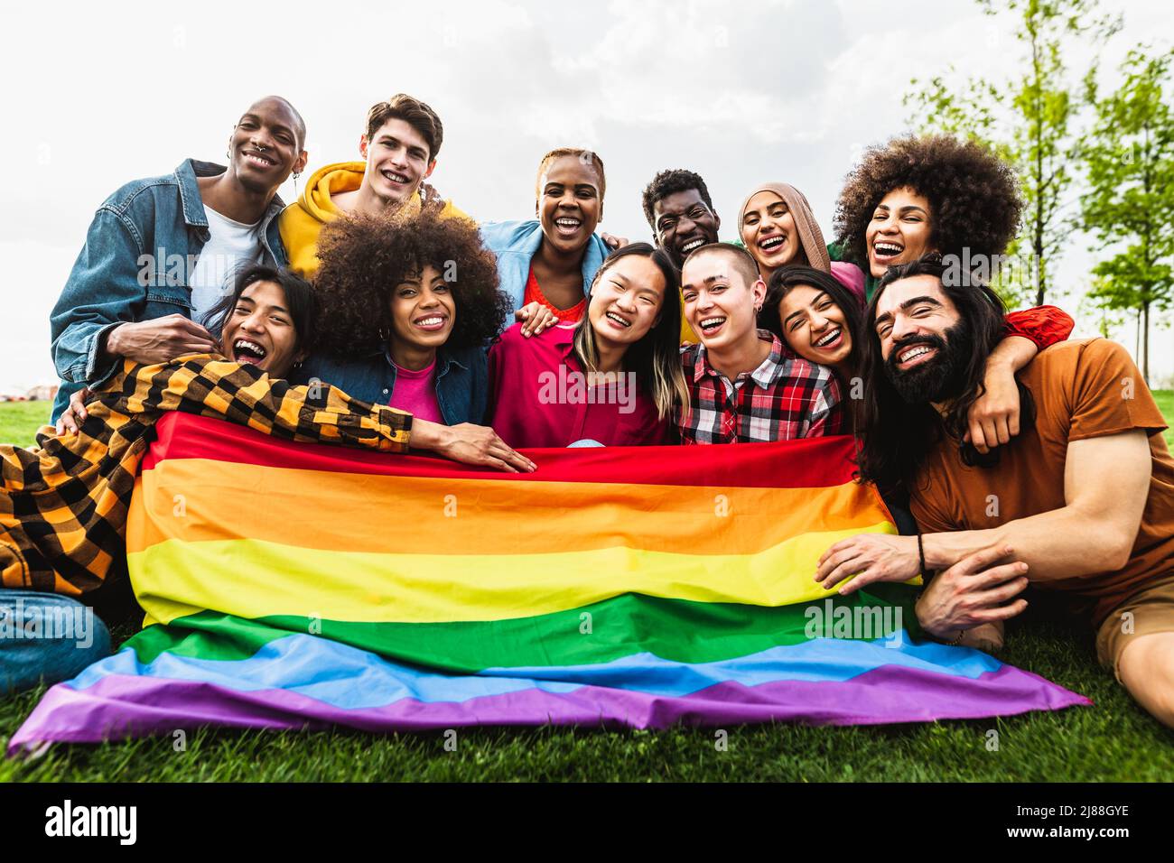 Happy diverse young friends celebrating gay pride festival - LGBTQ community concept Stock Photo