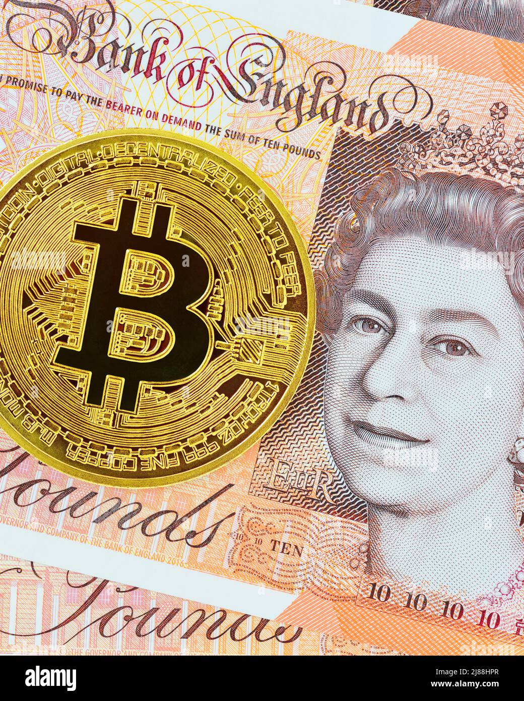 Bitcoin and a British Pound, United Kingdom Stock Photo