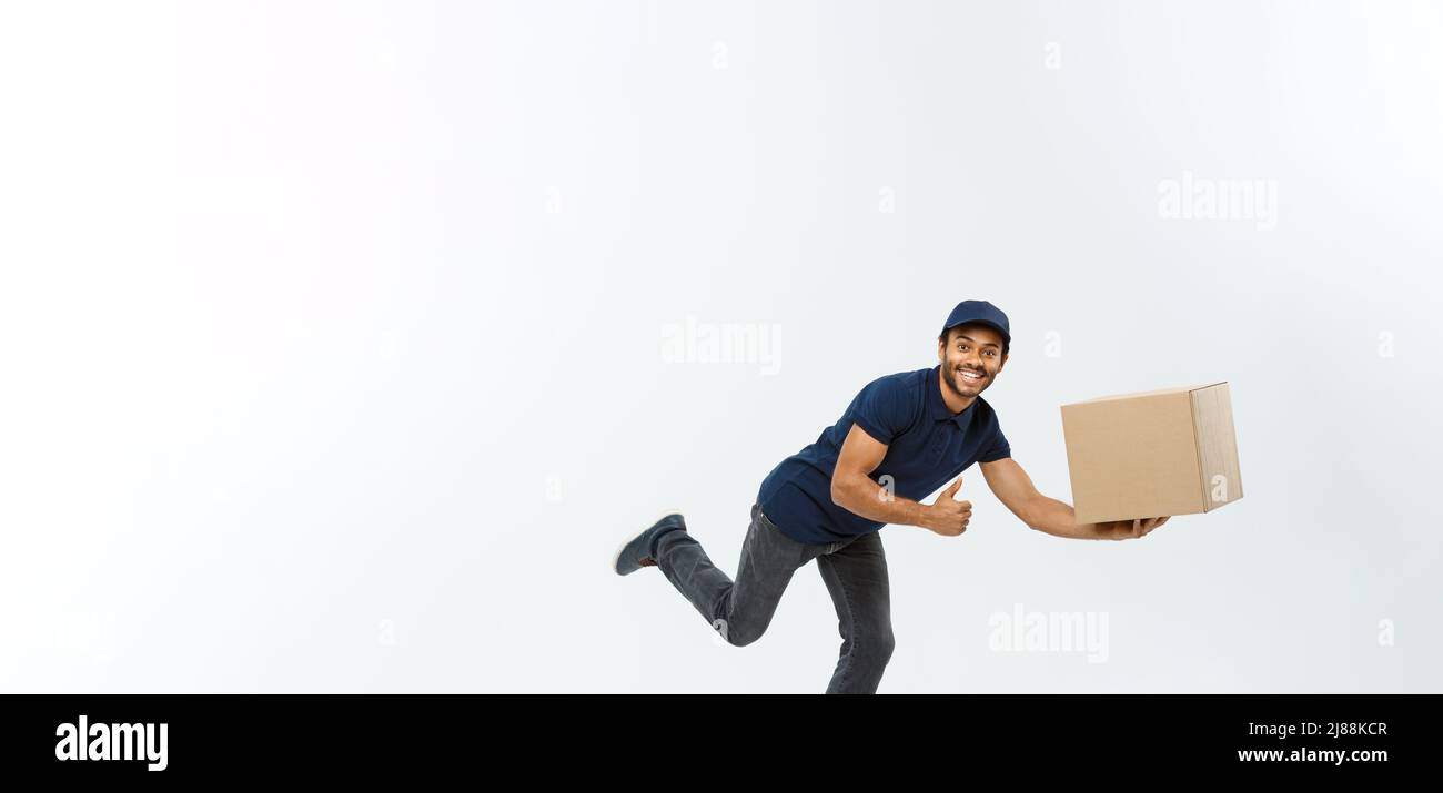 Delivery Concept - Handsome African American delivery man rush running ...