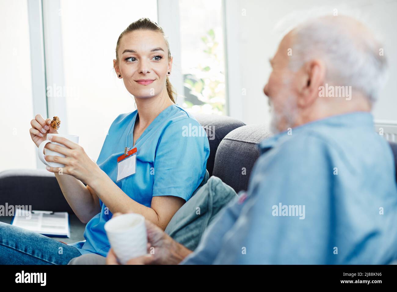 nurse doctor senior care caregiver help assistence retirement home nursing elderly man Stock Photo