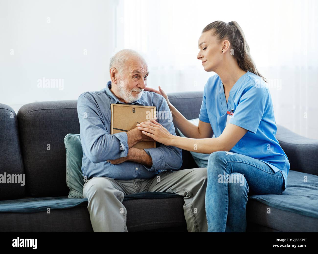 nurse doctor senior care caregiver picture sad help assistence retirement home memory nostalgia elderly man Stock Photo