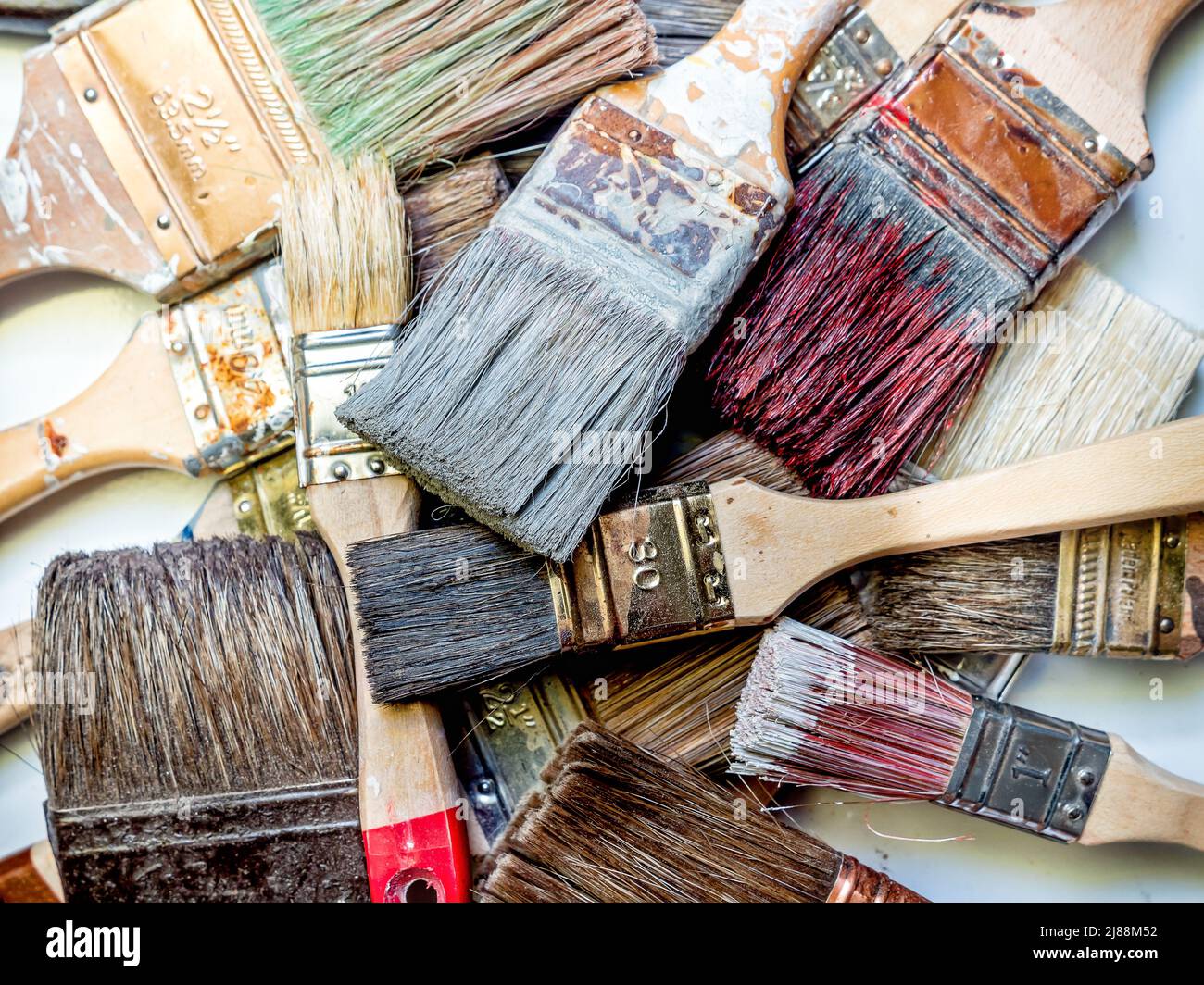 Pile of used and dried paint brushes shot from above Stock Photo