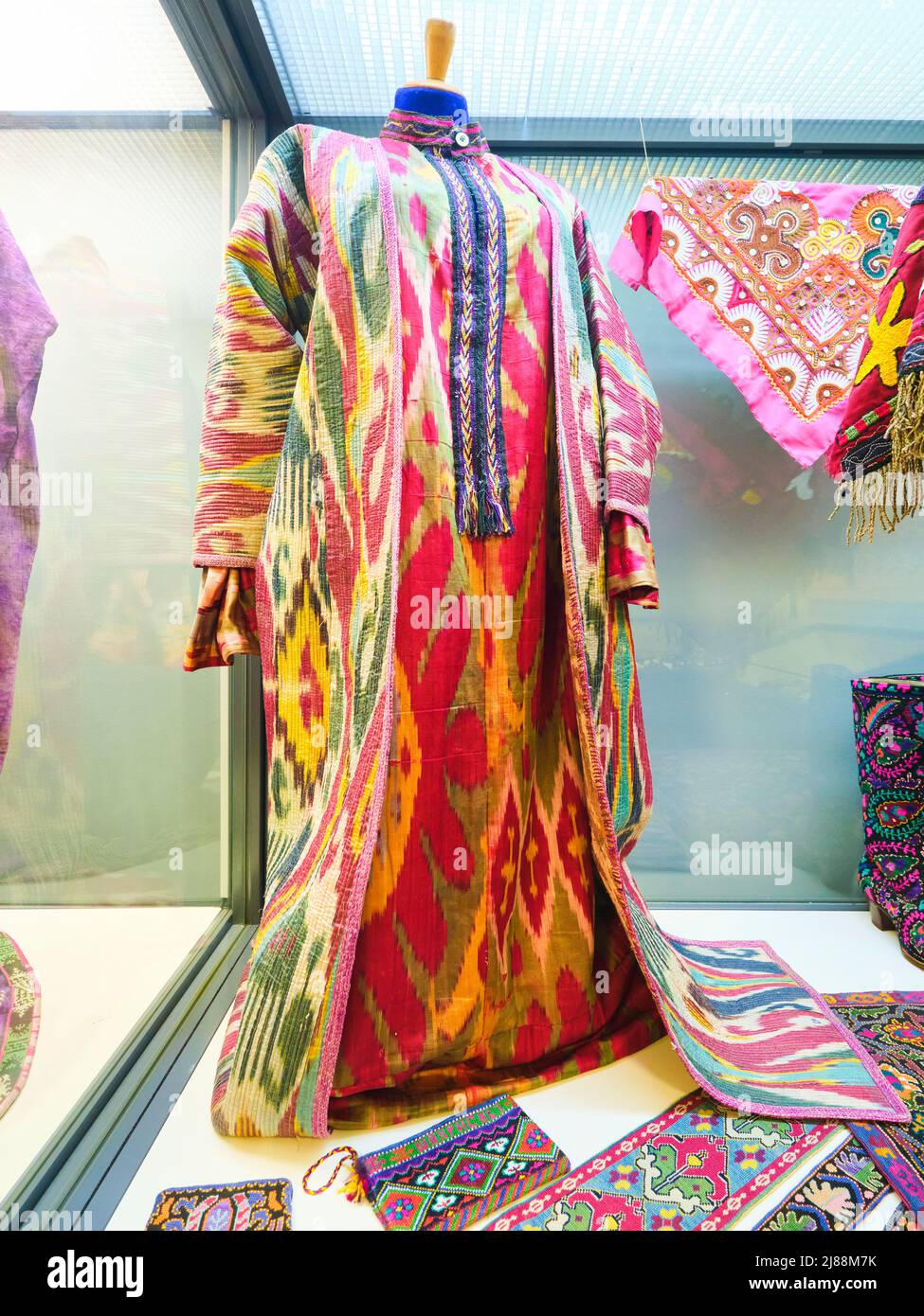 A display of ikat fabric for a traditional caftan, robe. At the Museum of Applied Arts in Tashkent, Uzbekistan. Stock Photo