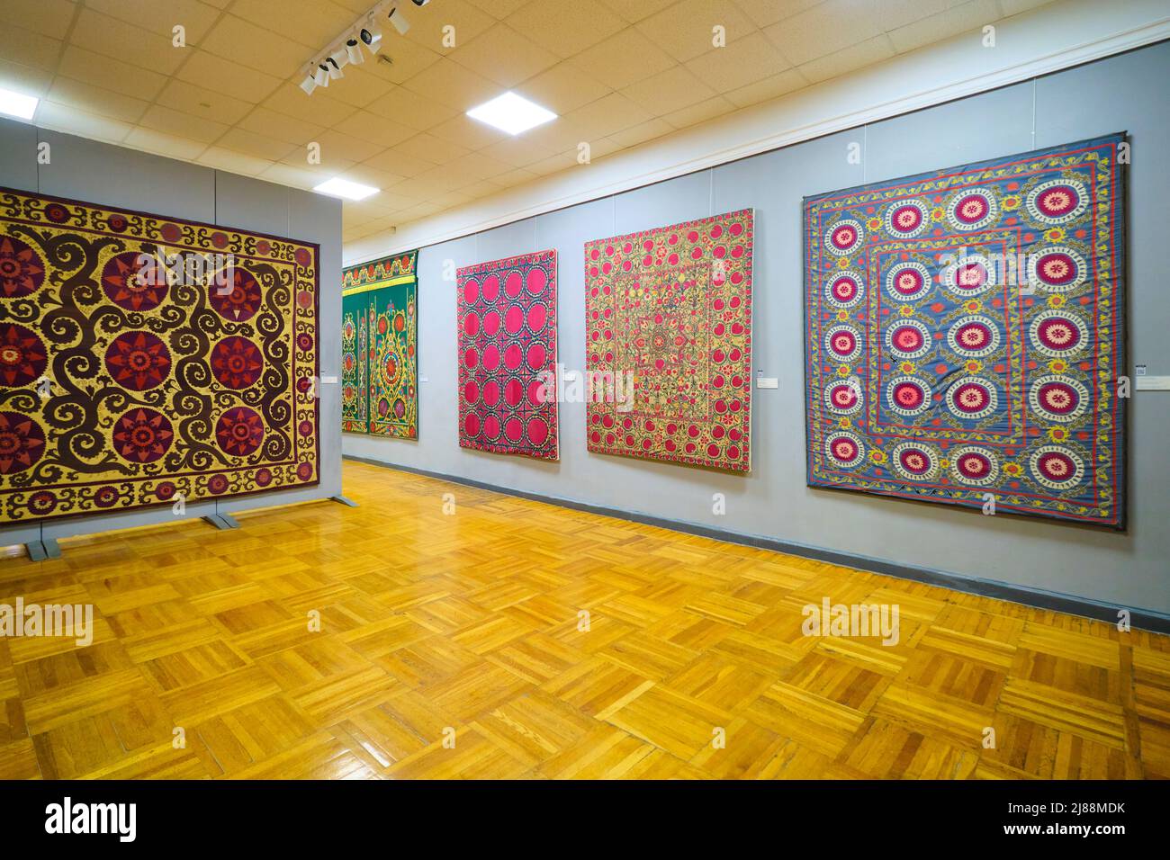 A display of traditional embroidery, suzani design work on textiles. At the Museum of Applied Arts in Tashkent, Uzbekistan. Stock Photo