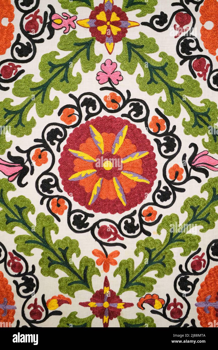 Pattern detail from a  display of traditional embroidery, suzani design work on textiles. At the Museum of Applied Arts in Tashkent, Uzbekistan. Stock Photo