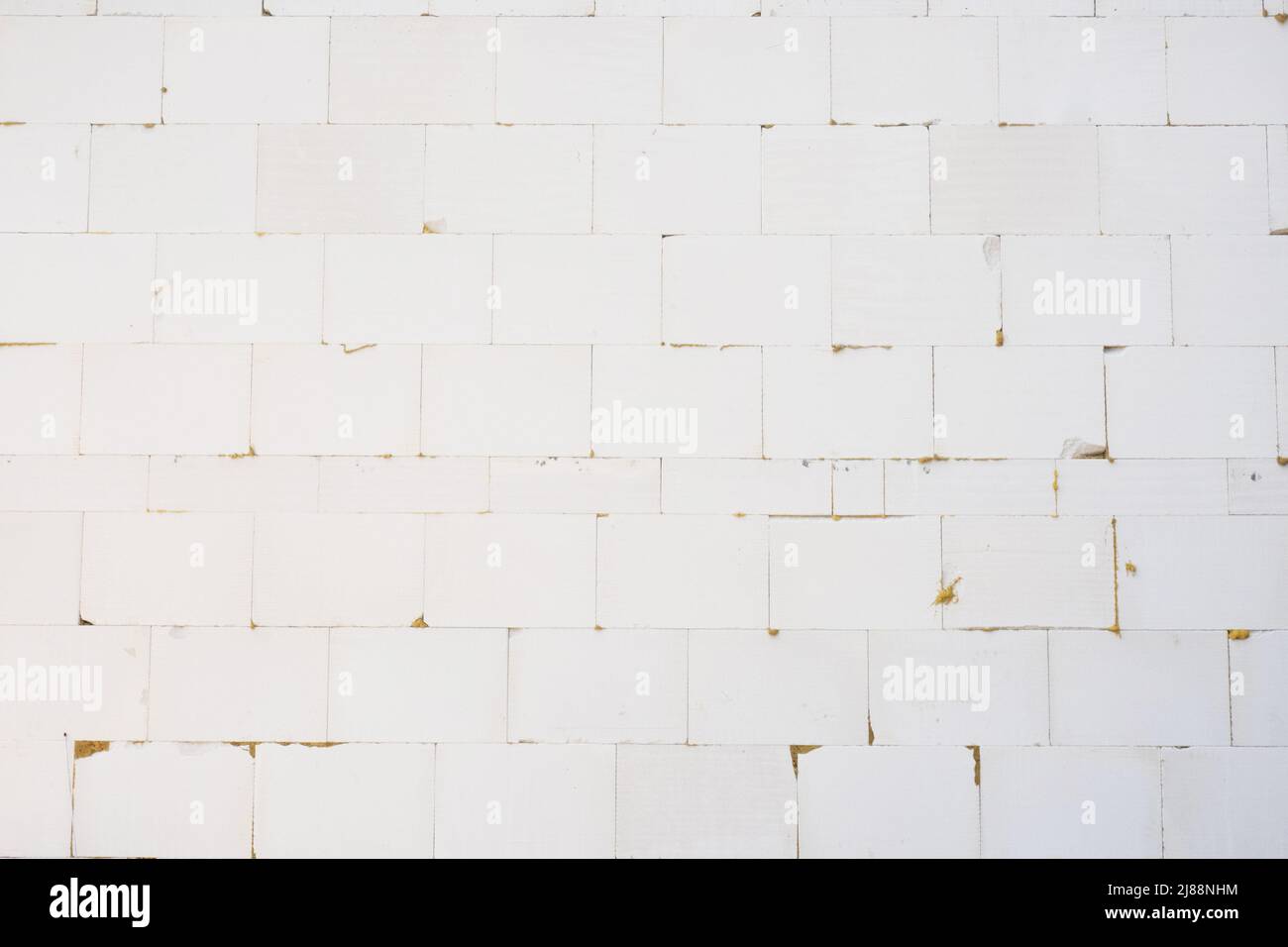 Wall of foam concrete blocks glued together with building glue Stock