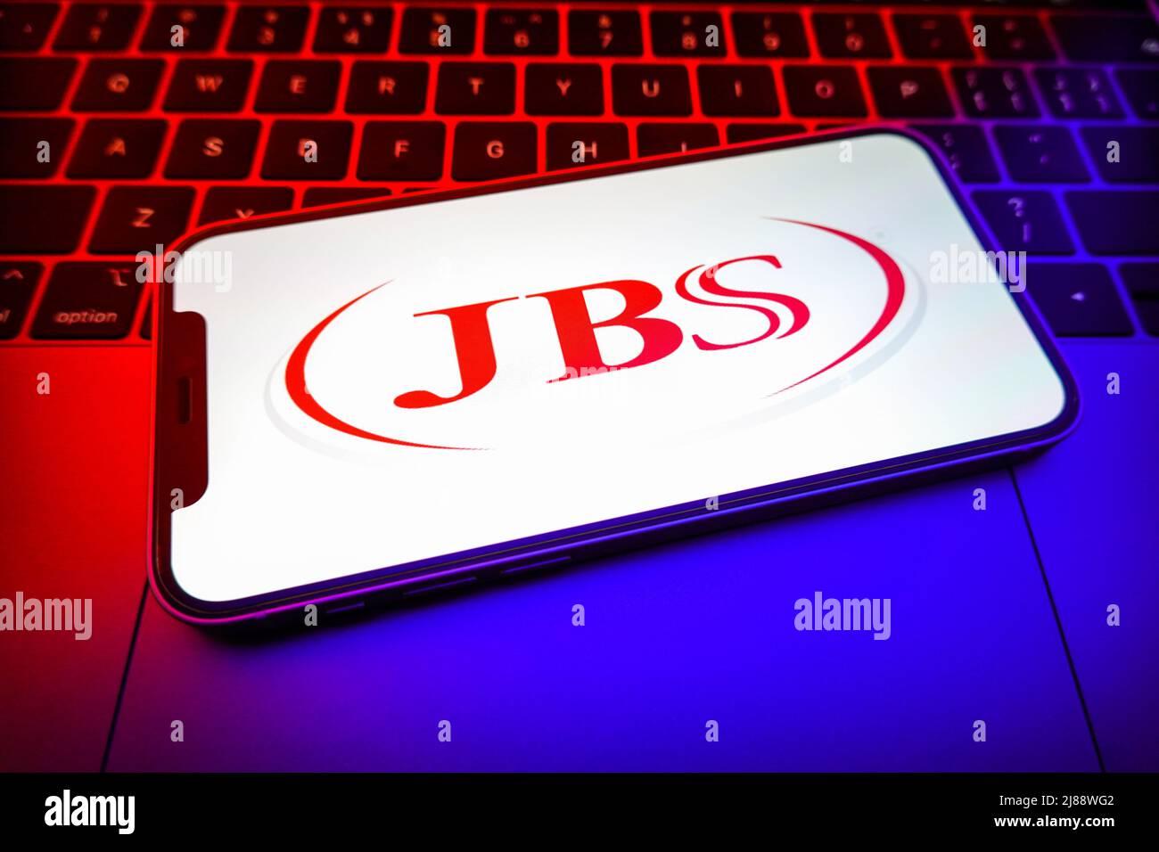 In this photo illustration, a JBS logo is displayed on the screen of a