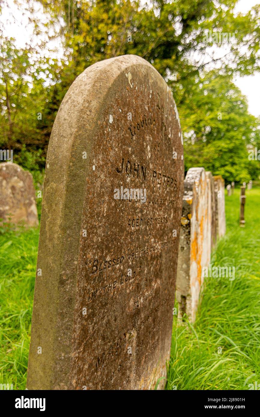 A line of headstones, probably dating back to the 19th Century. Stock Photo