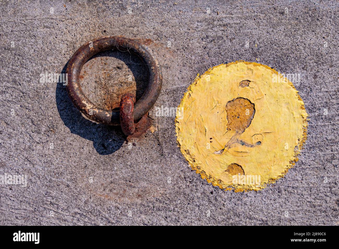 Mooring numbers and a tether on a quayside. Stock Photo