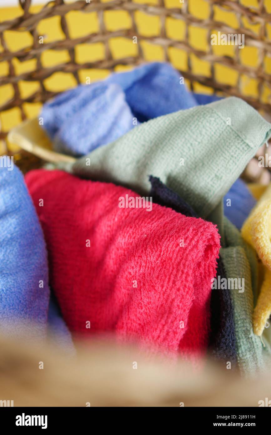 colorful towels in basket on floor Stock Photo Alamy
