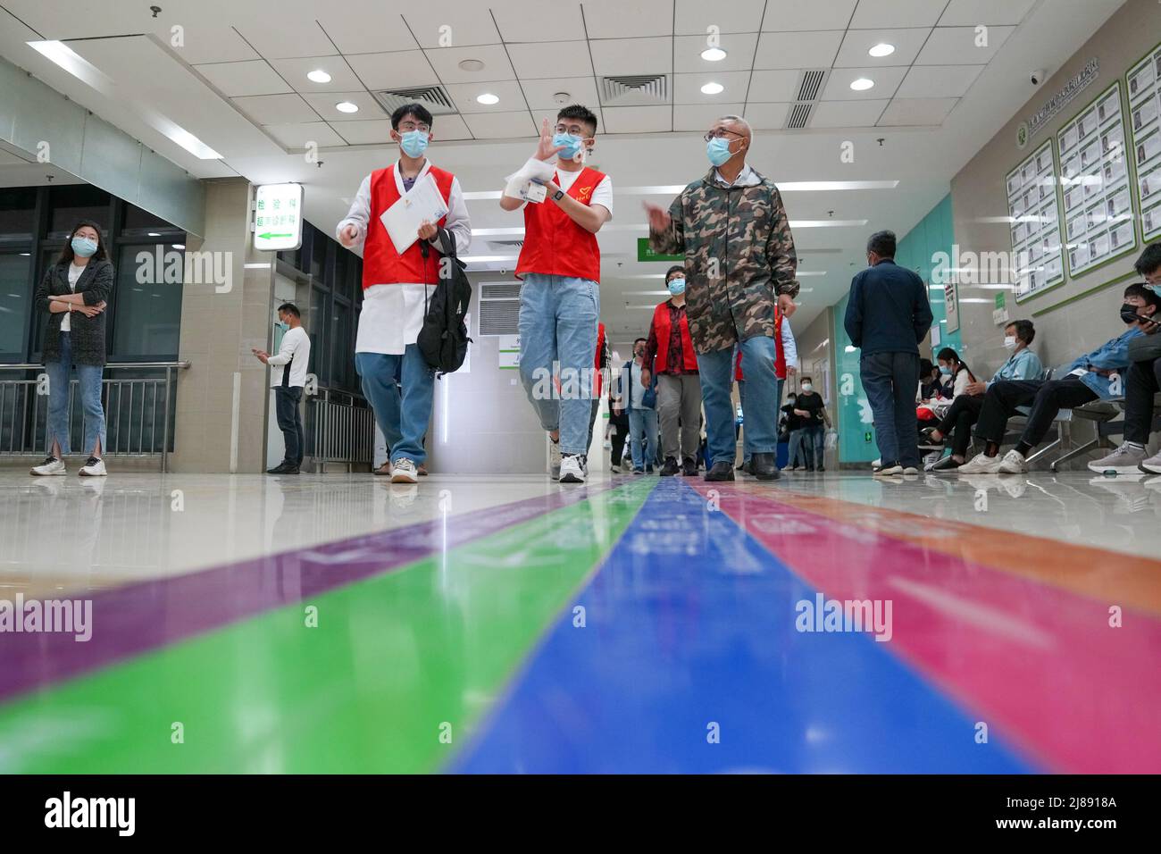 (220514) -- NANJING, May 14, 2022 (Xinhua) -- Chen Xin (C) accompanies a hearing-impaired patient (1st R) to see a doctor in a hospital in Nanjing, east China's Jiangsu Province, May 9, 2022. Chen Xin, a student of Nanjing Polytechnic Institute, also a certified sign language interpreter, established a workshop offering voluntary service for hearing-impaired people in September 2020. So far the workshop has organized over 80 sign language training courses and more than 100 voluntary events with an aggregate service time exceeding 1,000 hours. During COVID-19 pandemic, Chen has made a serie Stock Photo
