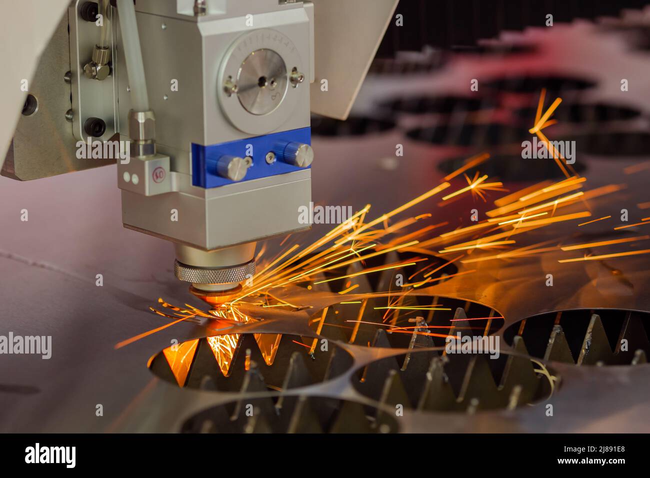 Laser cutting machine working with sheet metal with sparks Stock Photo