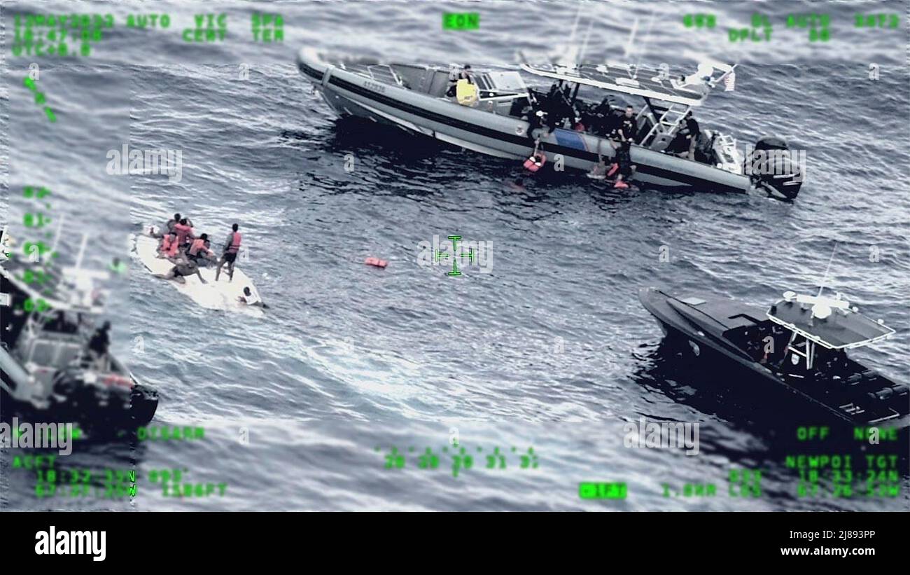 Caribbean Sea, Turks and Caicos. 12 May, 2022. A Coast Guard and Customs and Border Protection law enforcement boat crews rescue unidentified migrants after their boat capsized in the Mona Passage, May 12, 2022 near Desecheo Island, Puerto Rico. At least 11 people died and 38 were rescued. Stock Photo