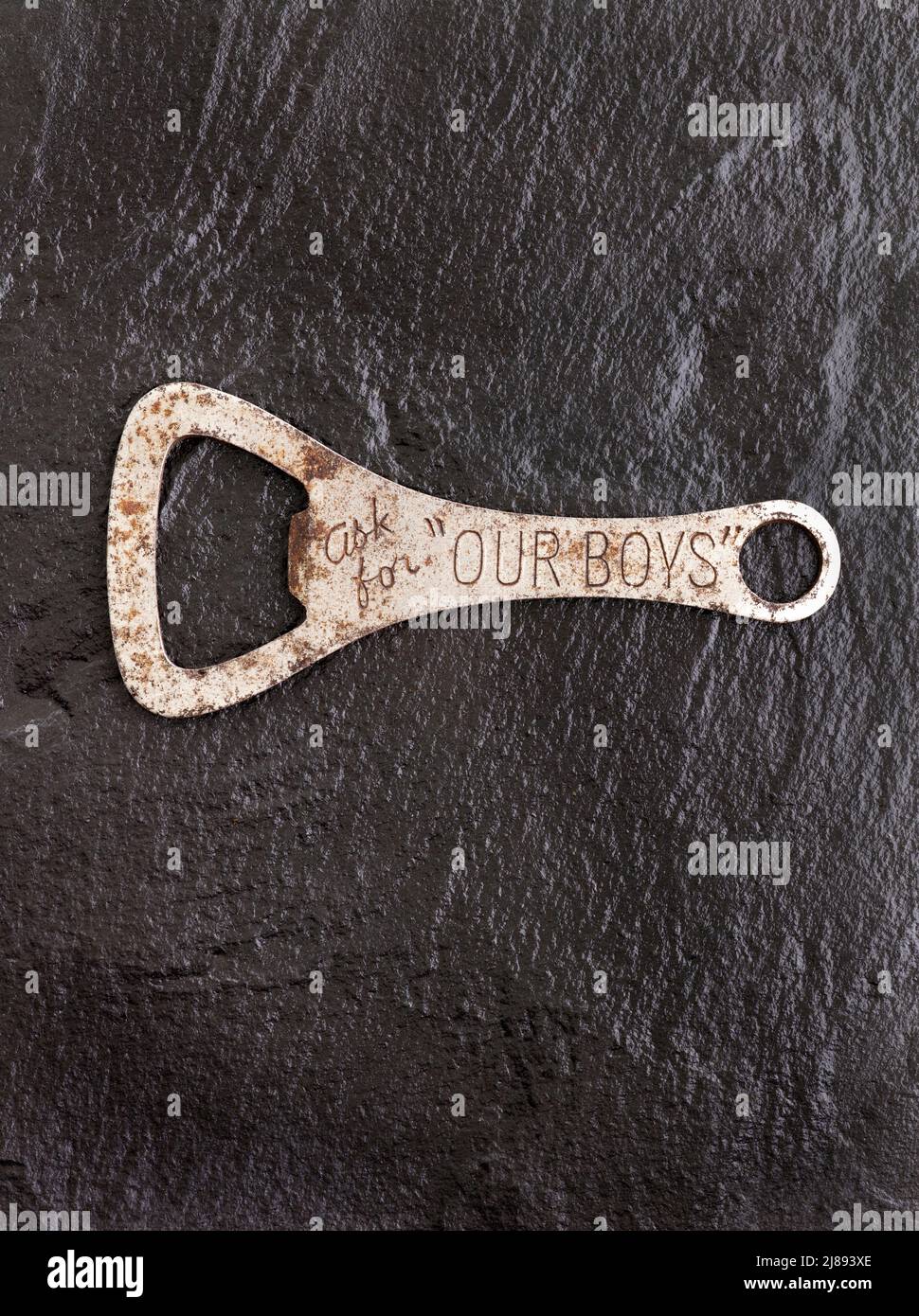 Ask For Our Boys - Old vintage bottle opener Stock Photo