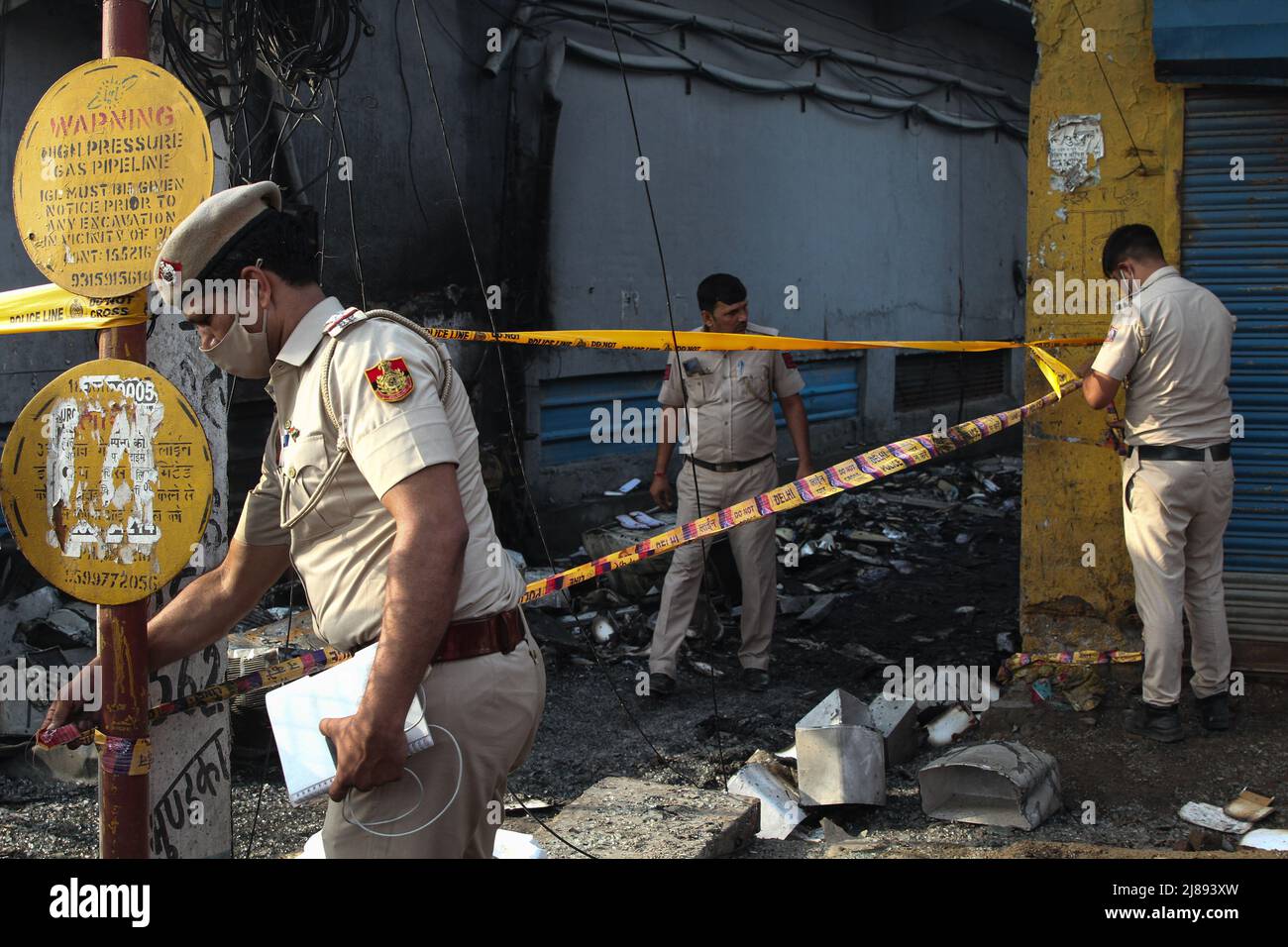 New Delhi, India. 14th May, 2022. Police officials seal an area at the site of a commercial building that caught fire. (Credit Image: © Karma Sonam Bhutia/ZUMA Press Wire) Credit: ZUMA Press, Inc./Alamy Live News Stock Photo