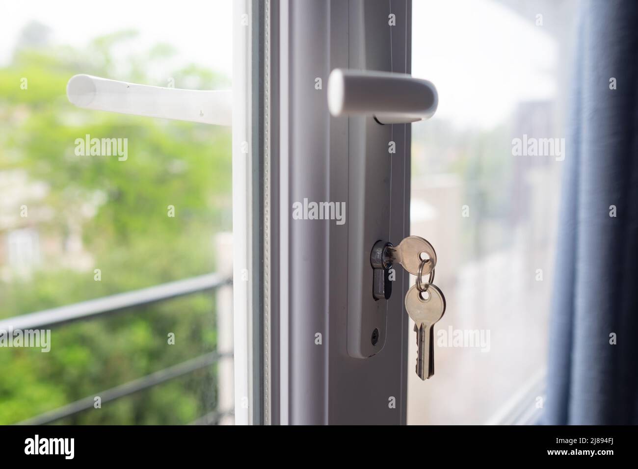 keys on the balcony door. Safety for child at home. Closing door at