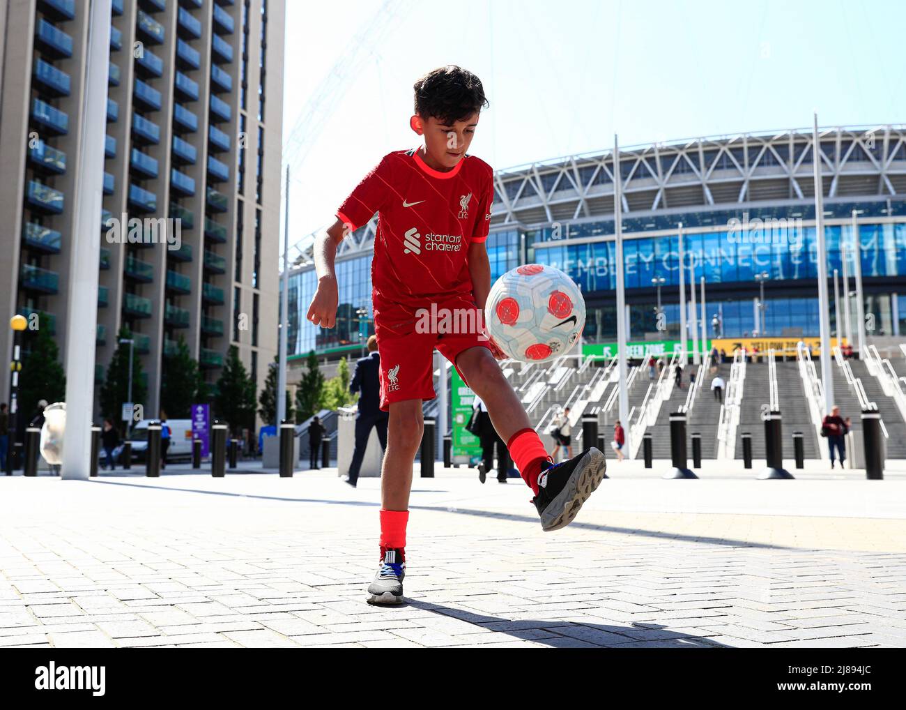 14th May 2022 ; Wembley Stadium, London England; FA Cup Final, Chelsea versus Liverpool: Young Liverpool fan doing Keepie uppie's outside Wembley Stadium Stock Photo